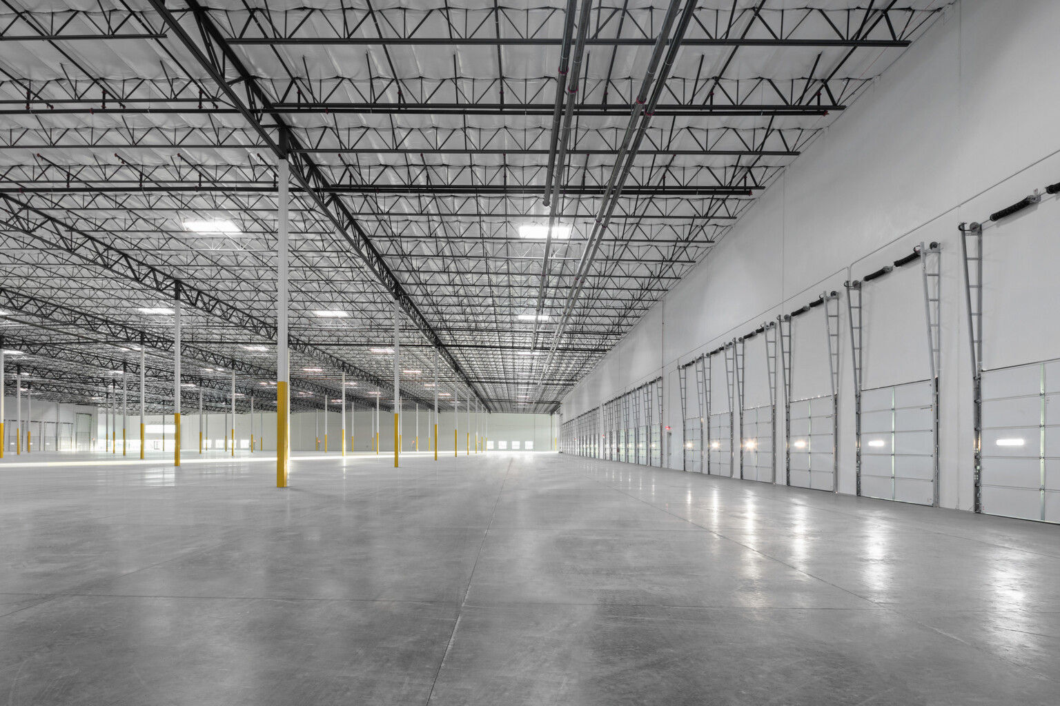 Avondale Commerce Park speculative office area; double-height window system at entry flooding interior with natural light; soaring ceiling height accommodating future two-story office build-out or single-story with generous ceiling height; open unfinished interior ready for tenant improvement
