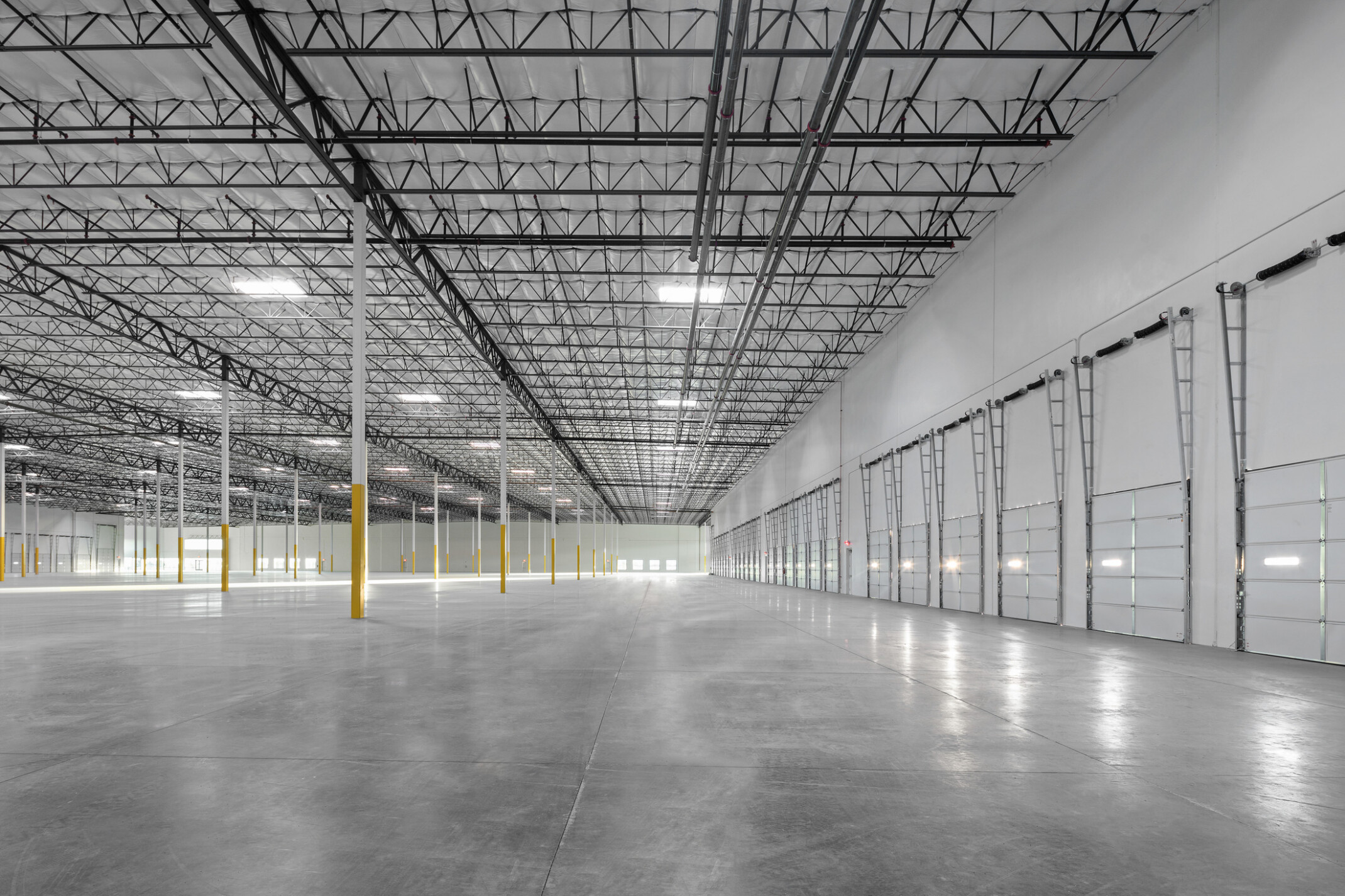 Avondale Commerce Park speculative office area; double-height window system at entry flooding interior with natural light; soaring ceiling height accommodating future two-story office build-out or single-story with generous ceiling height; open unfinished interior ready for tenant improvement