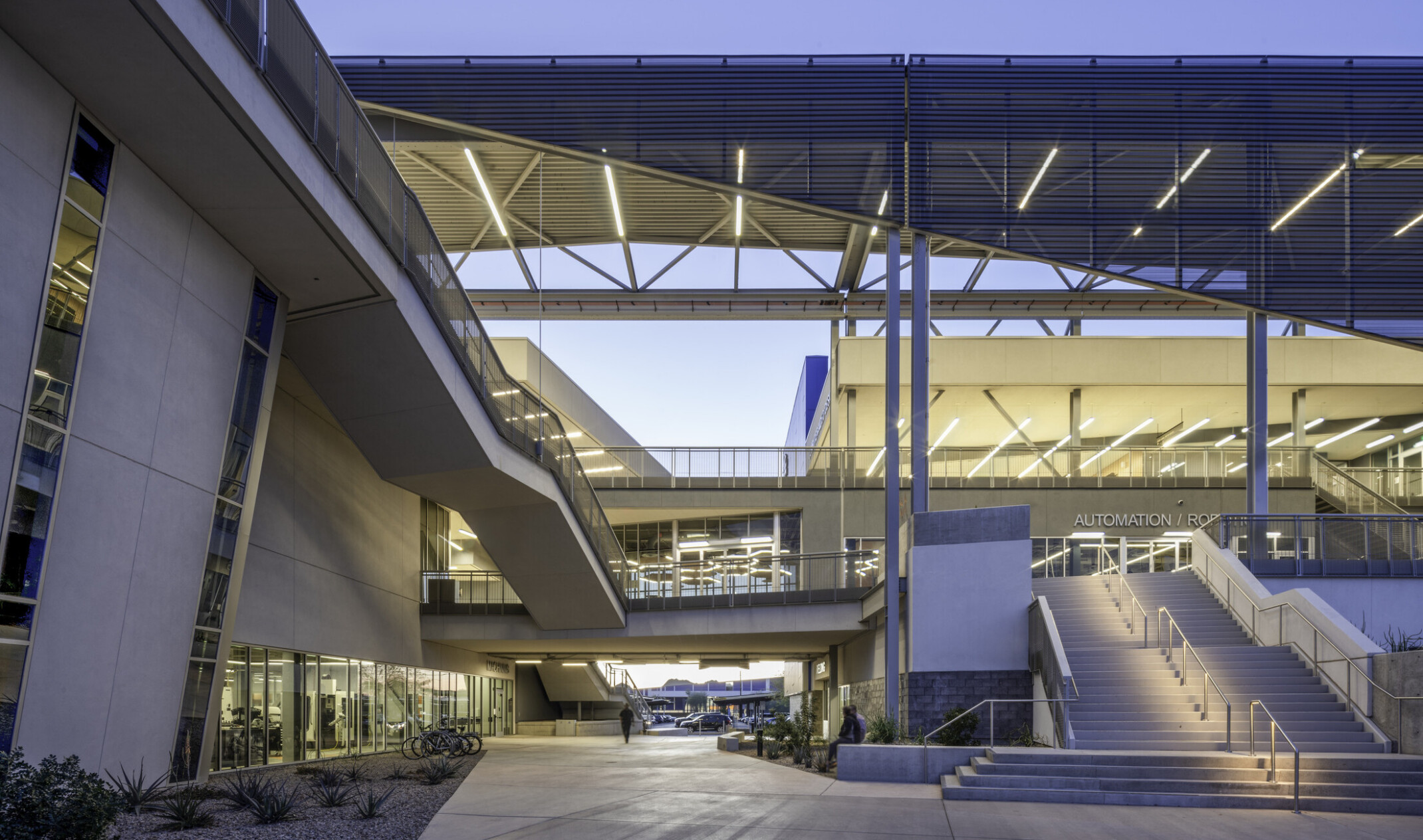central atrium for an outdoor-indoor learning space; lots of stairs leading to different buildings and platforms