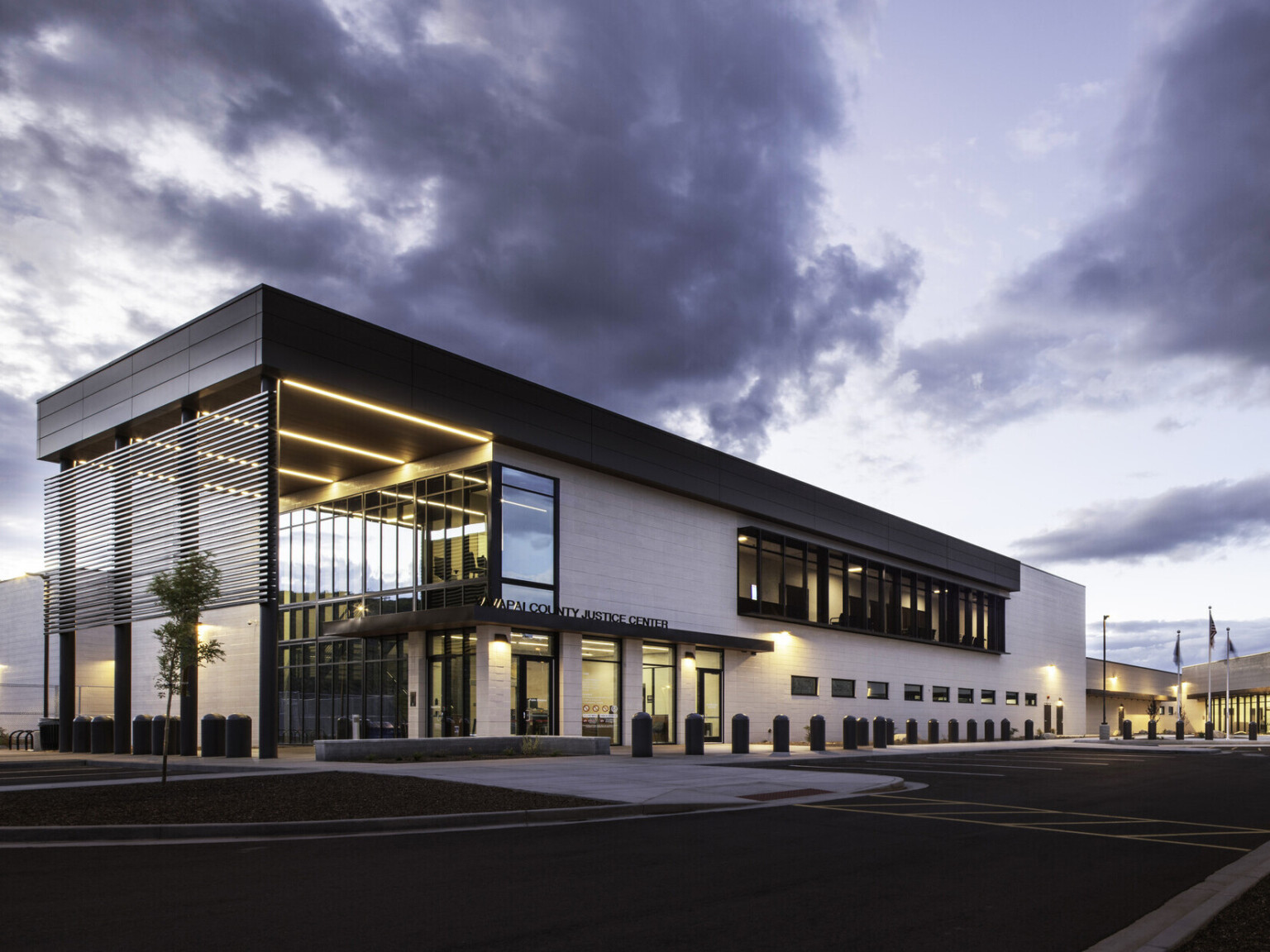 Exterior of Yavapai County Criminal Justice Center. Natural materials, floor to ceiling windows, building entrance