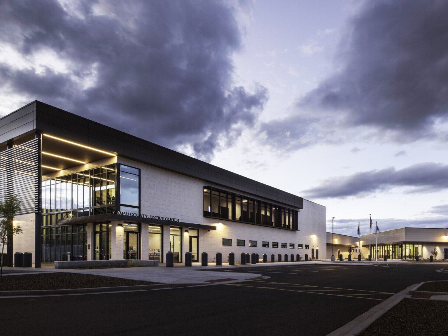 Exterior of Yavapai County Criminal Justice Center. Natural materials, floor to ceiling windows, building entrance