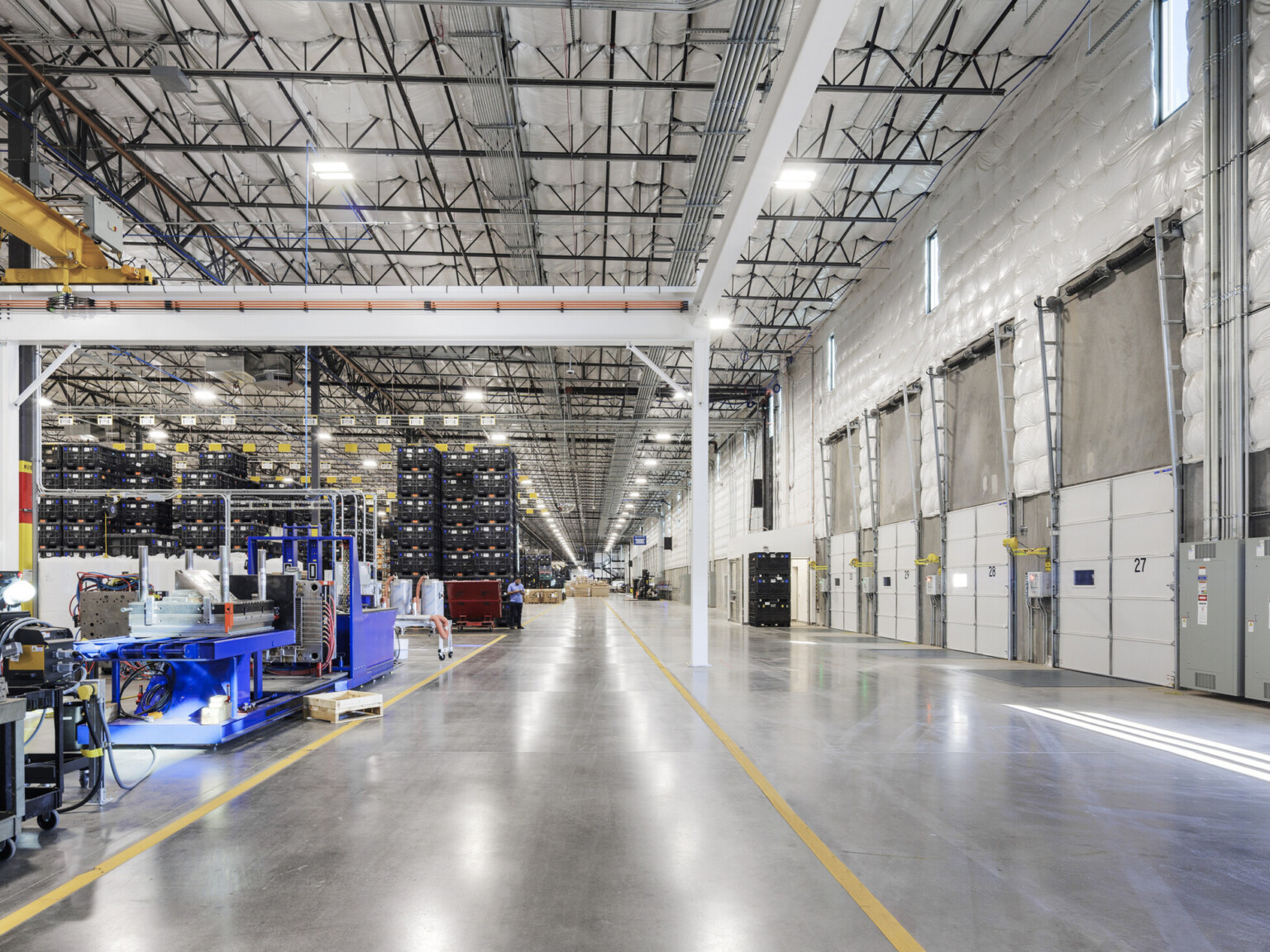 Sub-Zero Group production floor; loading dock with large overhead doors; overhead rail and frame system for material handling