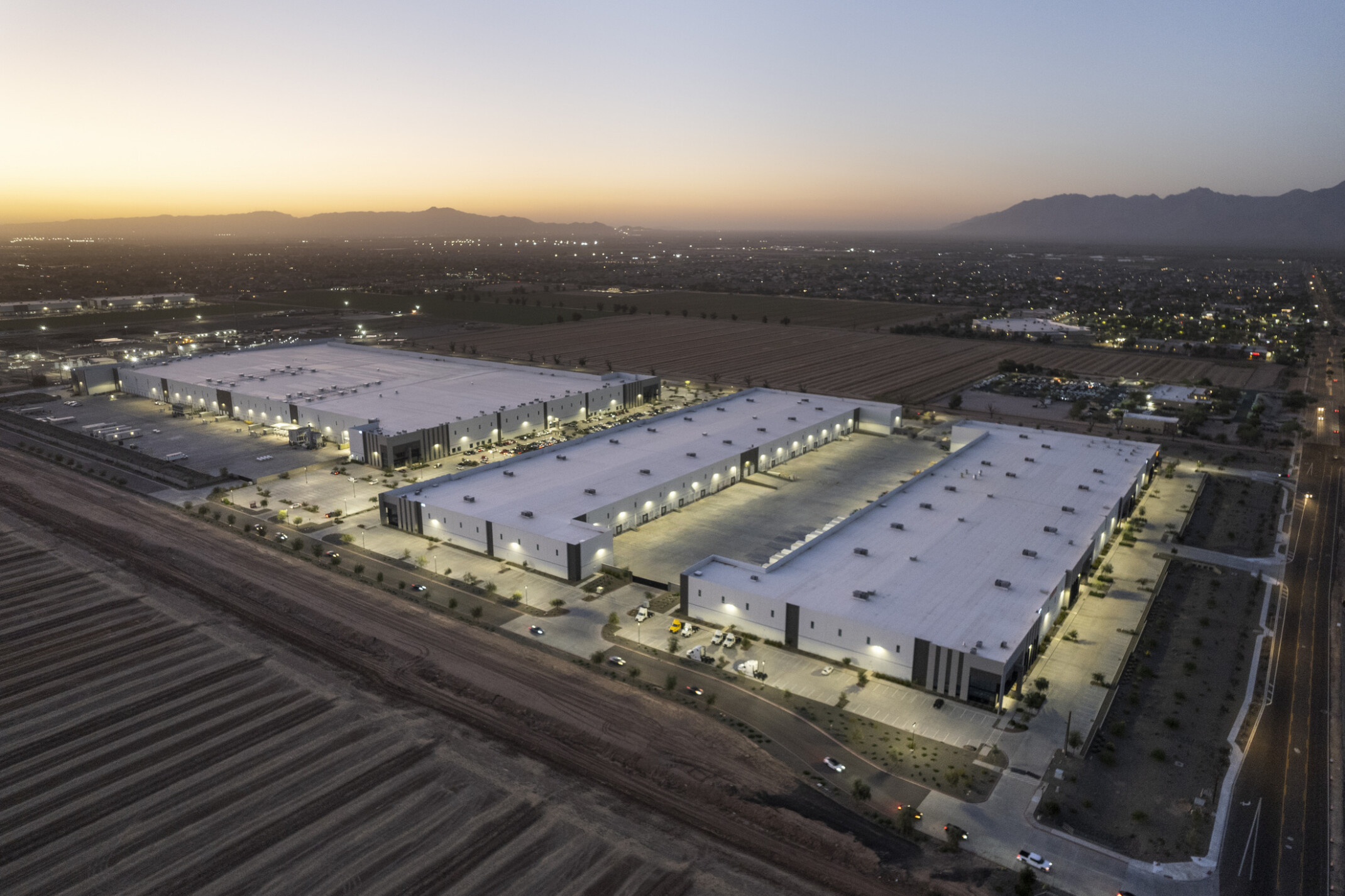 Aerial view of GO | 99 South's largest building, showing its white facade, high-bay windows, and expansive truck court.