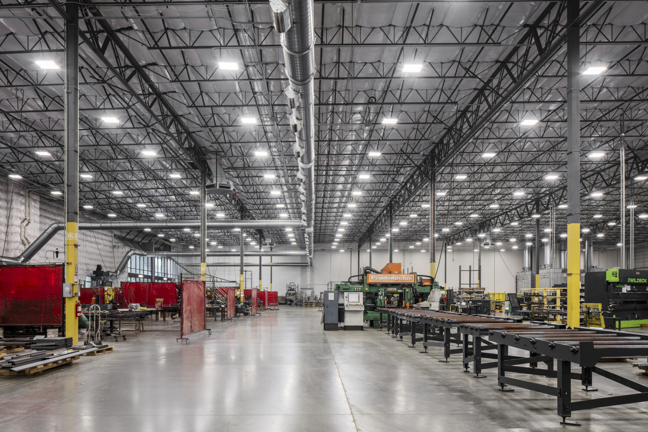 Wildeck manufacturing floor; corridor lined with production machinery on either side used to build Wildeck's products