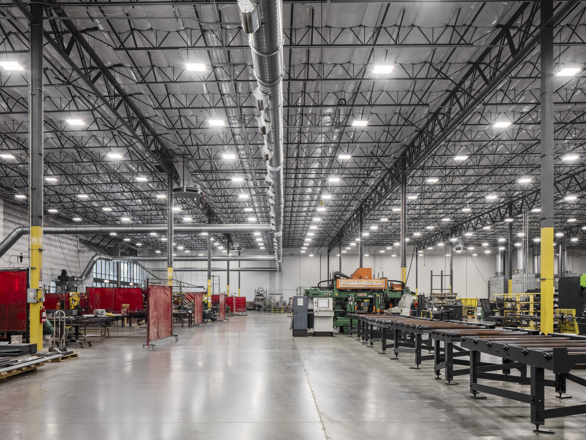 Wildeck manufacturing floor; corridor lined with production machinery on either side used to build Wildeck's products