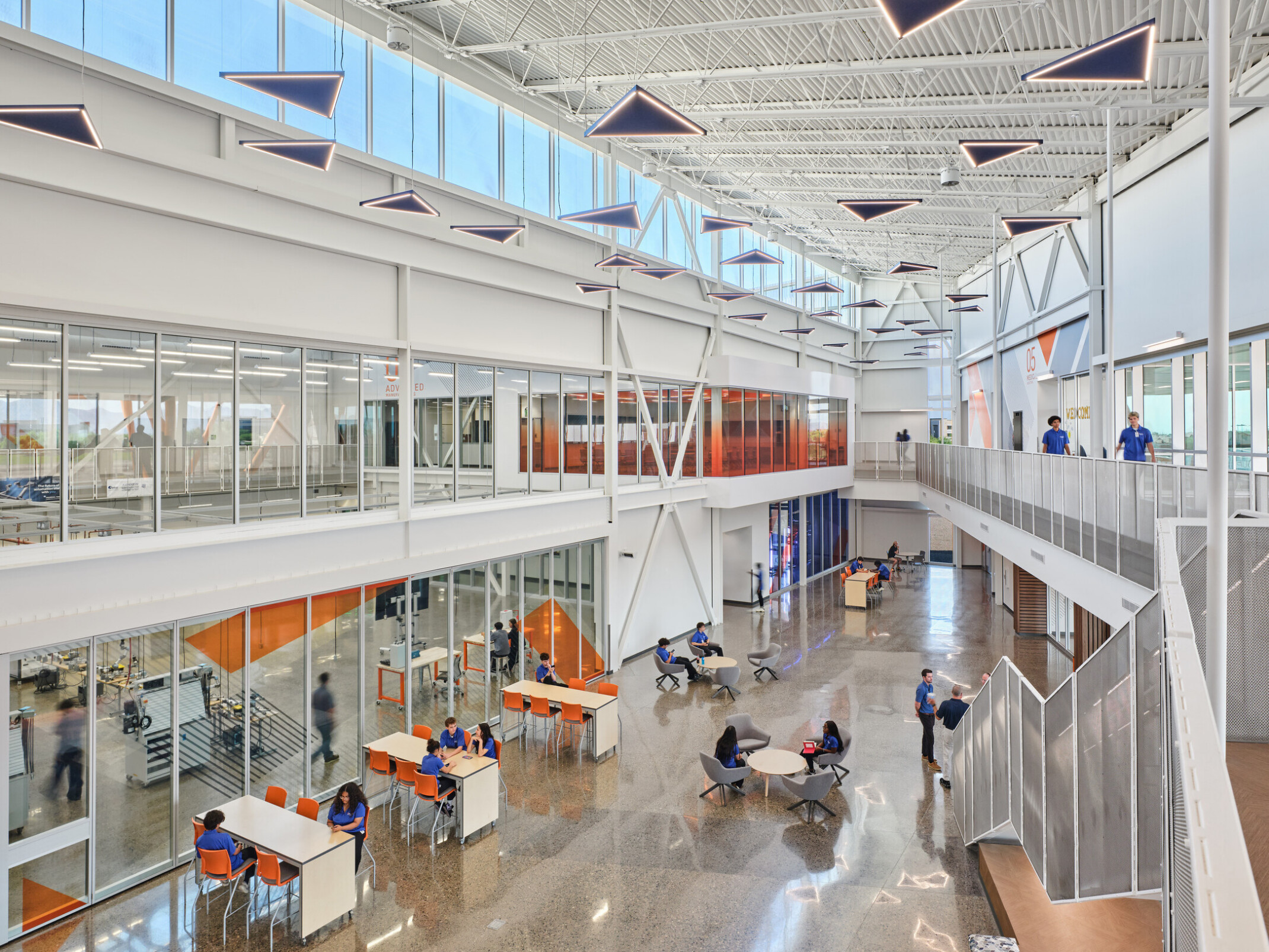 interior white framing welcomes students in a large open entryway; varied seating