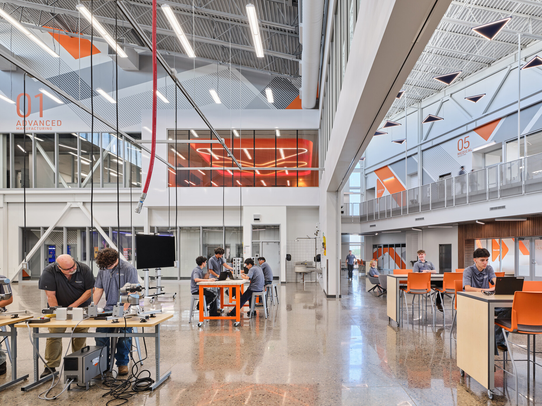 interior white framing technical classroom with students at desk stations working with equipment throughout