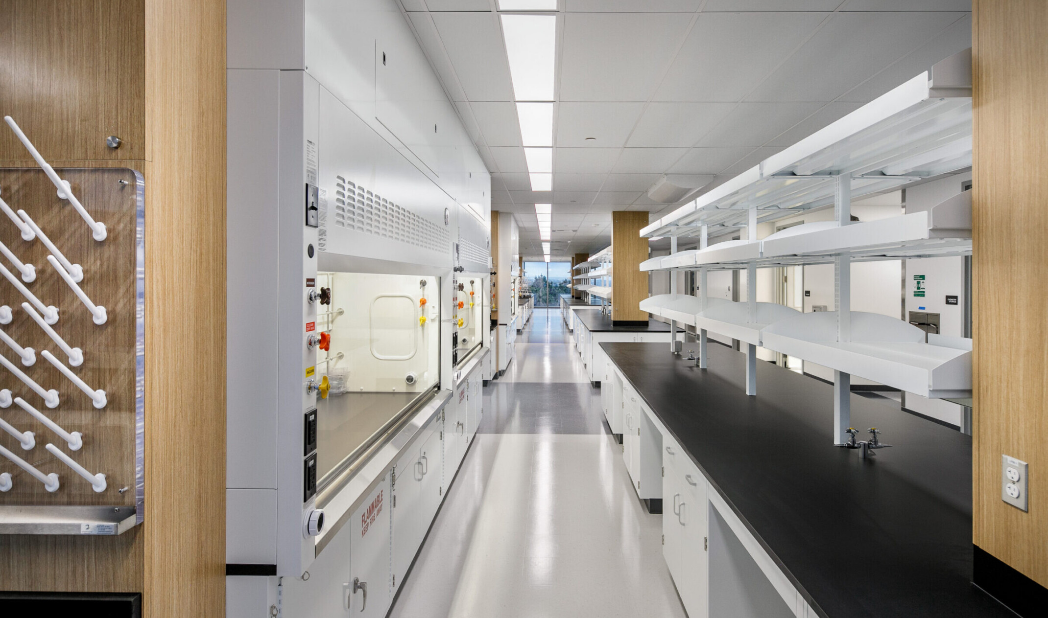 lab space; looking down a row of stations with technical equipment on either counter