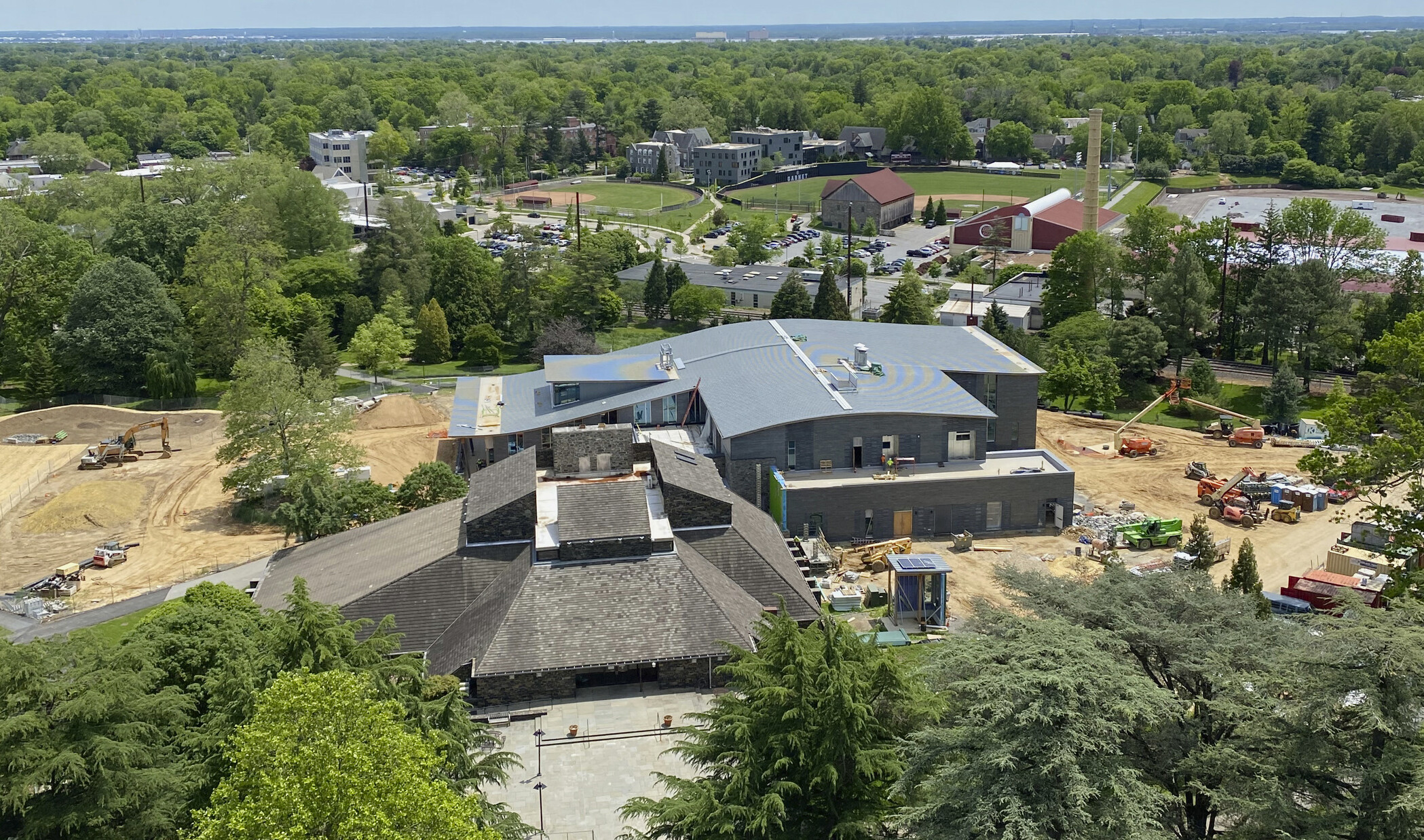 Aerial view of Swarthmore College new community dining center while under construction, a stone building with curved roof