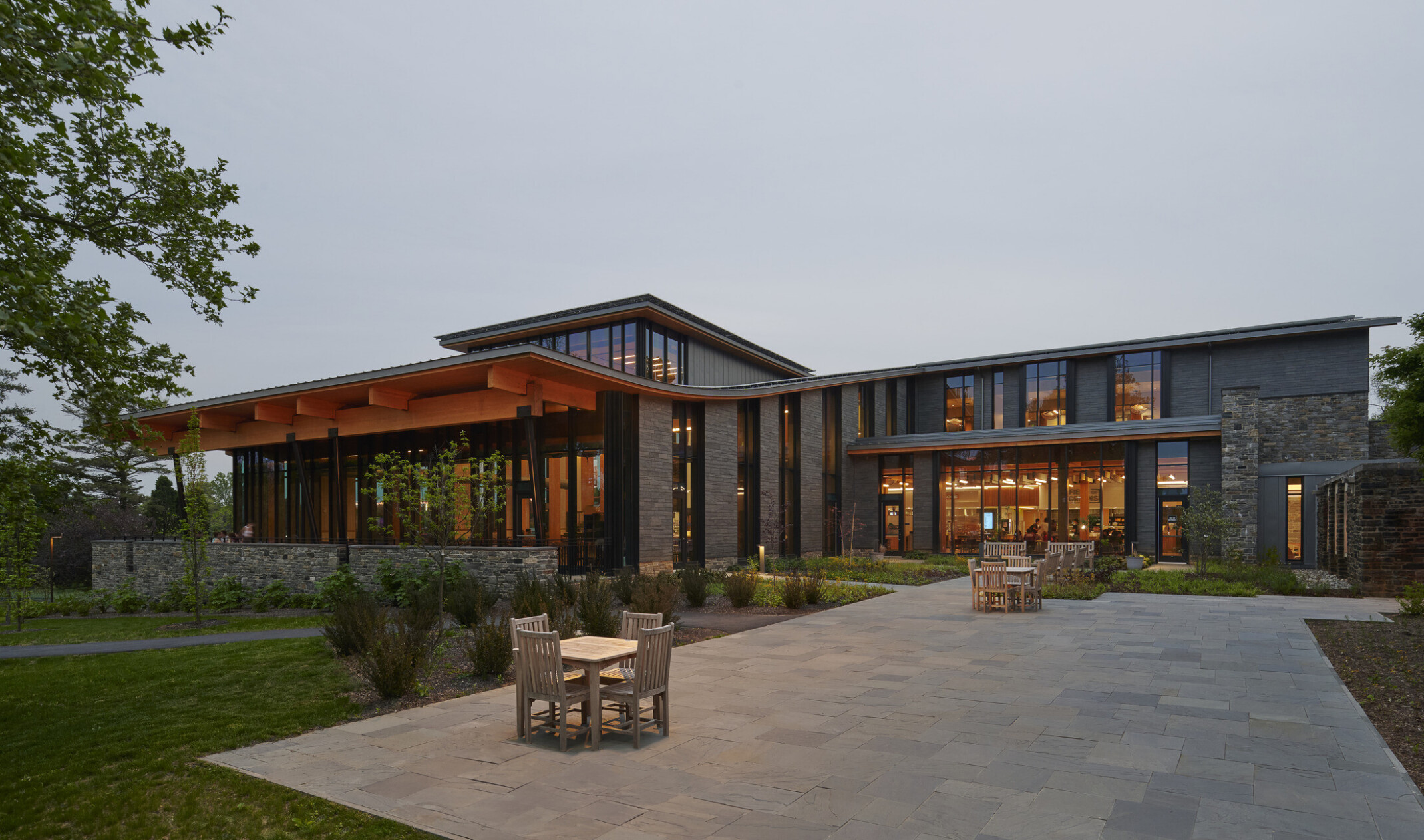 Walkway to swarthmore dining facility, students sitting around exterior flexible seating, mass timber architecture, what is mass timber construction