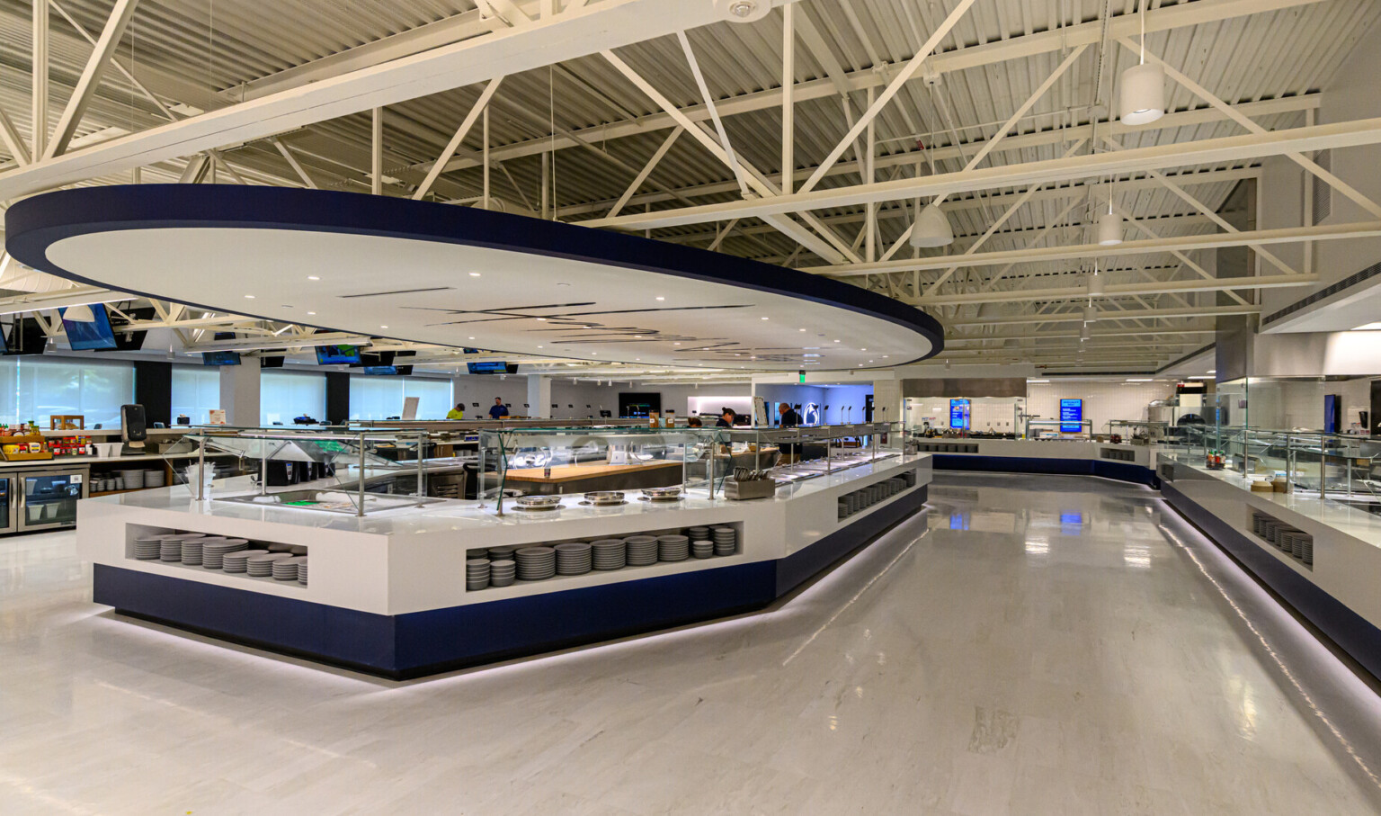Penn State’s Greenberg Indoor Sports Complex dining space; large white buffet counter in the center of the room with similar counters on the perimeter of the space