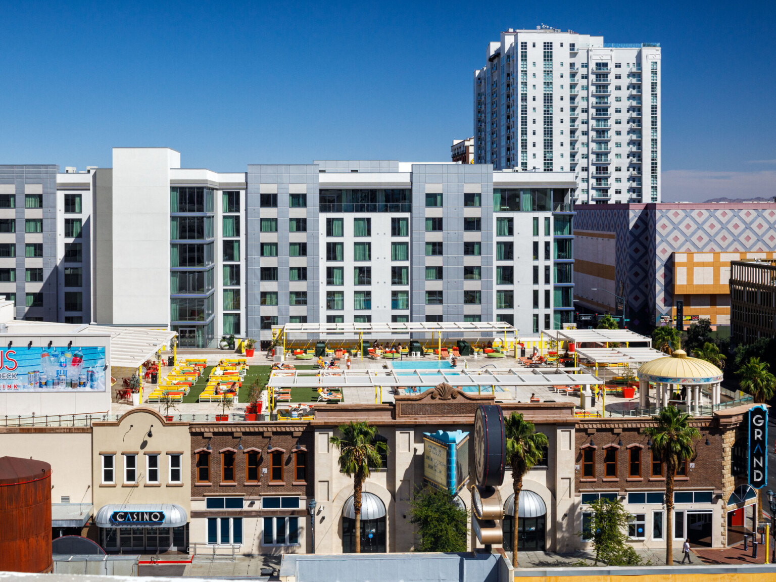 Aerial view of multistory buildings, with a swimming pool on a building roof