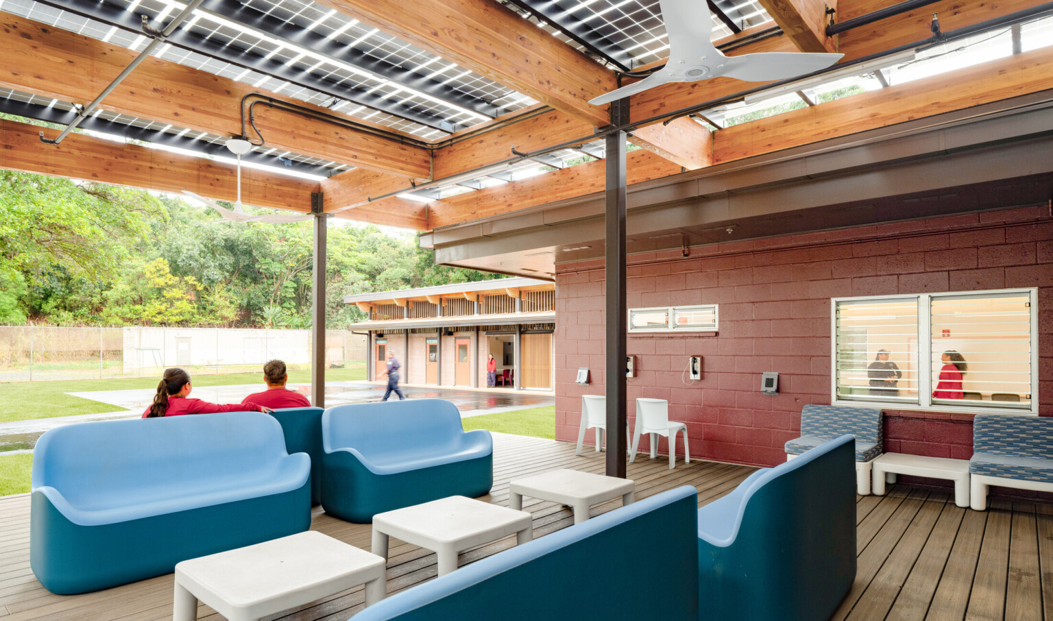 shaded patio area with moveable furniture and an overhead sun canopy for passive cooling; Ho‘okipa Makai Cottage