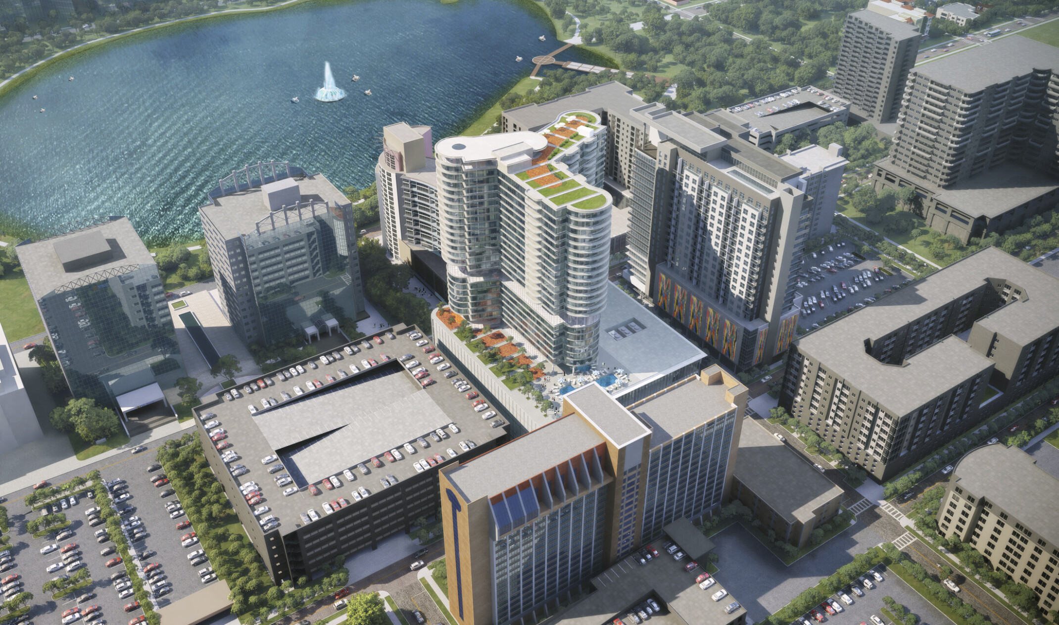 Aerial view of back of building with roof top gardens and pool in city near water