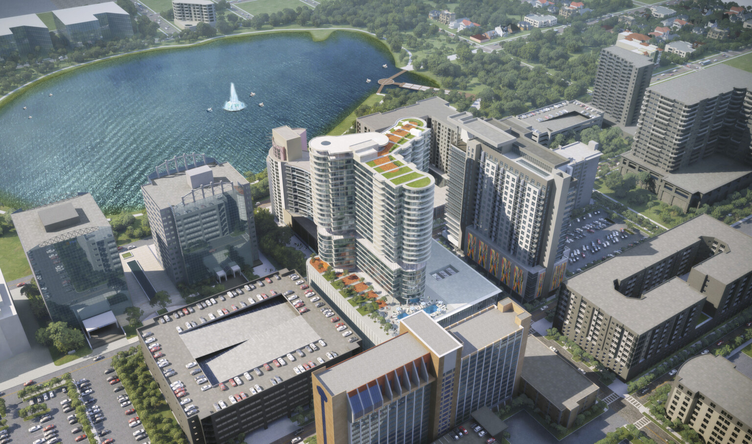 Aerial view of back of building with roof top gardens and pool in city near water