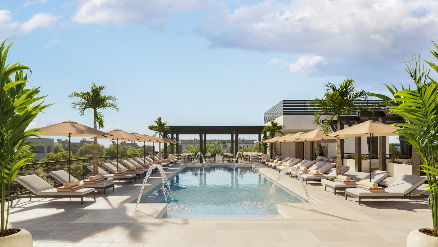 Rectangular swimming pool lined with lounge chairs with tan cushion, tan umbrellas, looking at a dark wood pergola