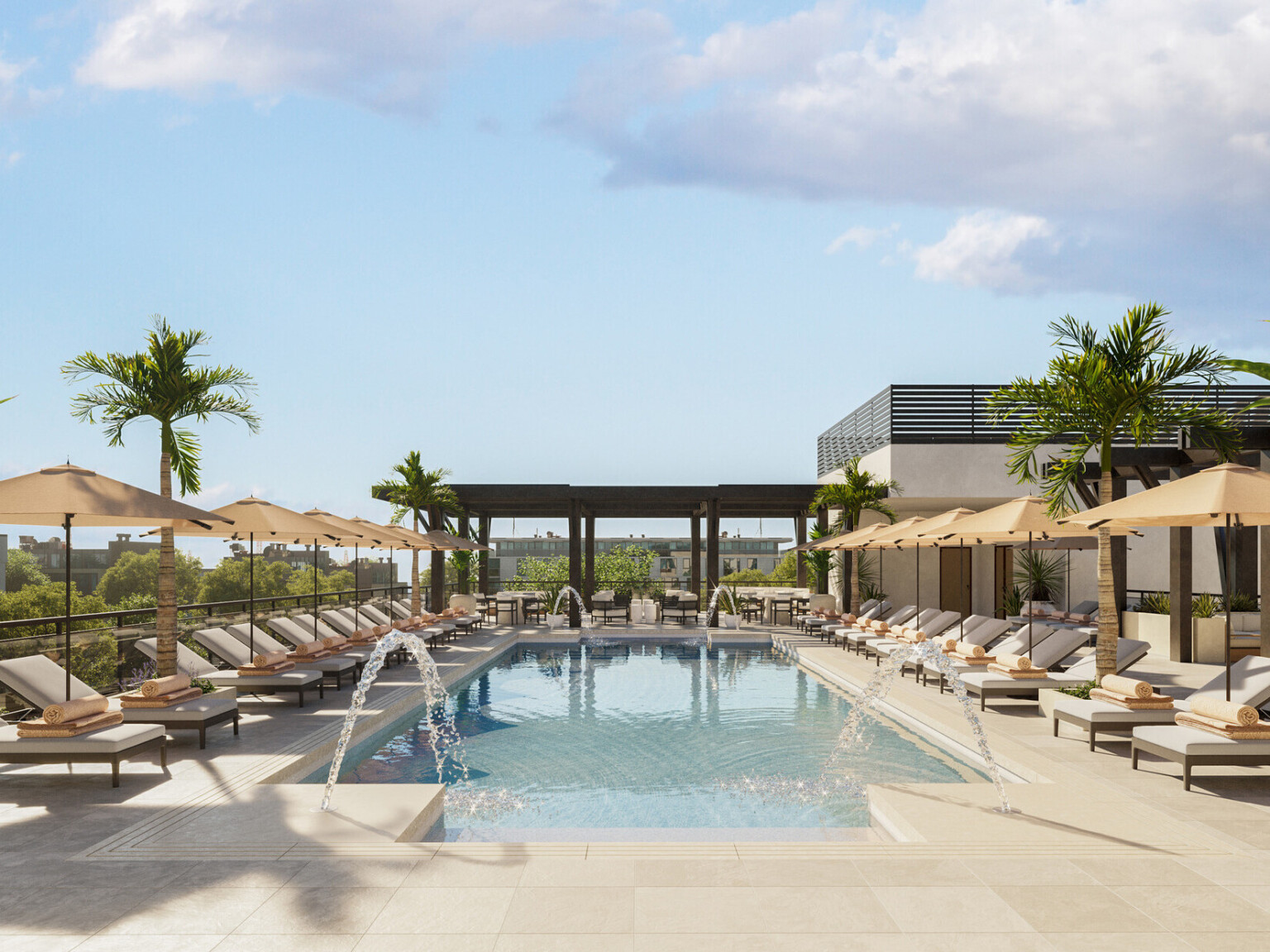 Rectangular swimming pool lined with lounge chairs with tan cushion, tan umbrellas, looking at a dark wood pergola