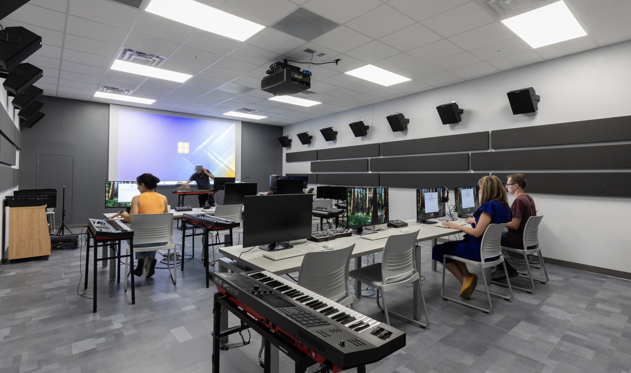 Recording studio with students working at sound boards and computers