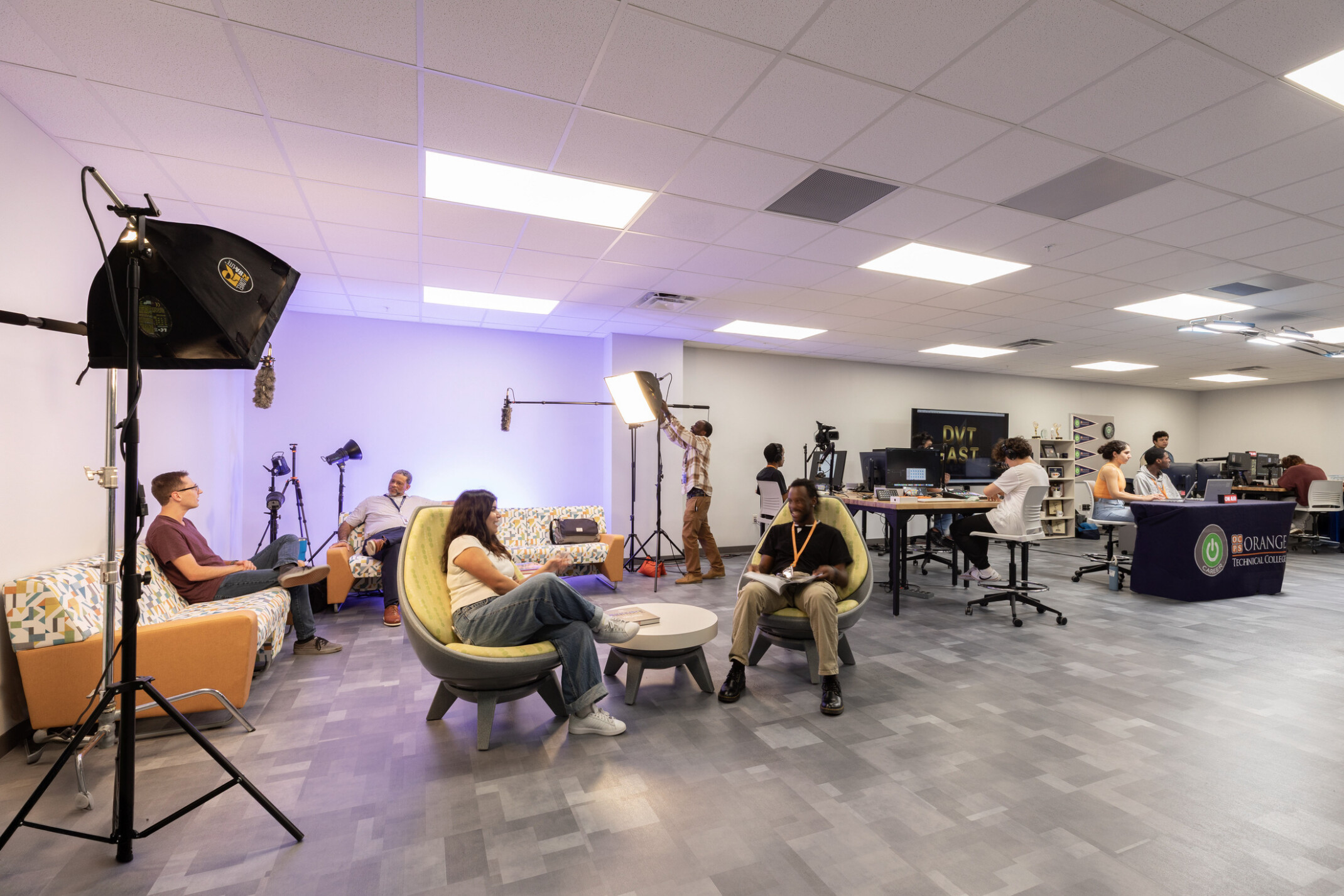 Simulation real-world classroom with recording and podcast studios; students at each station