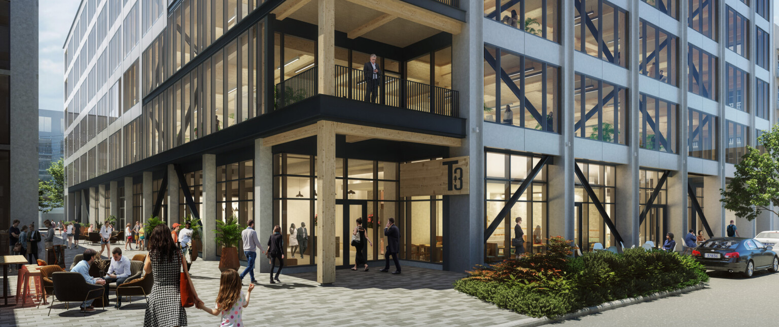 Multistory office building with black and white beams filled with windows, black railings and wooden accents