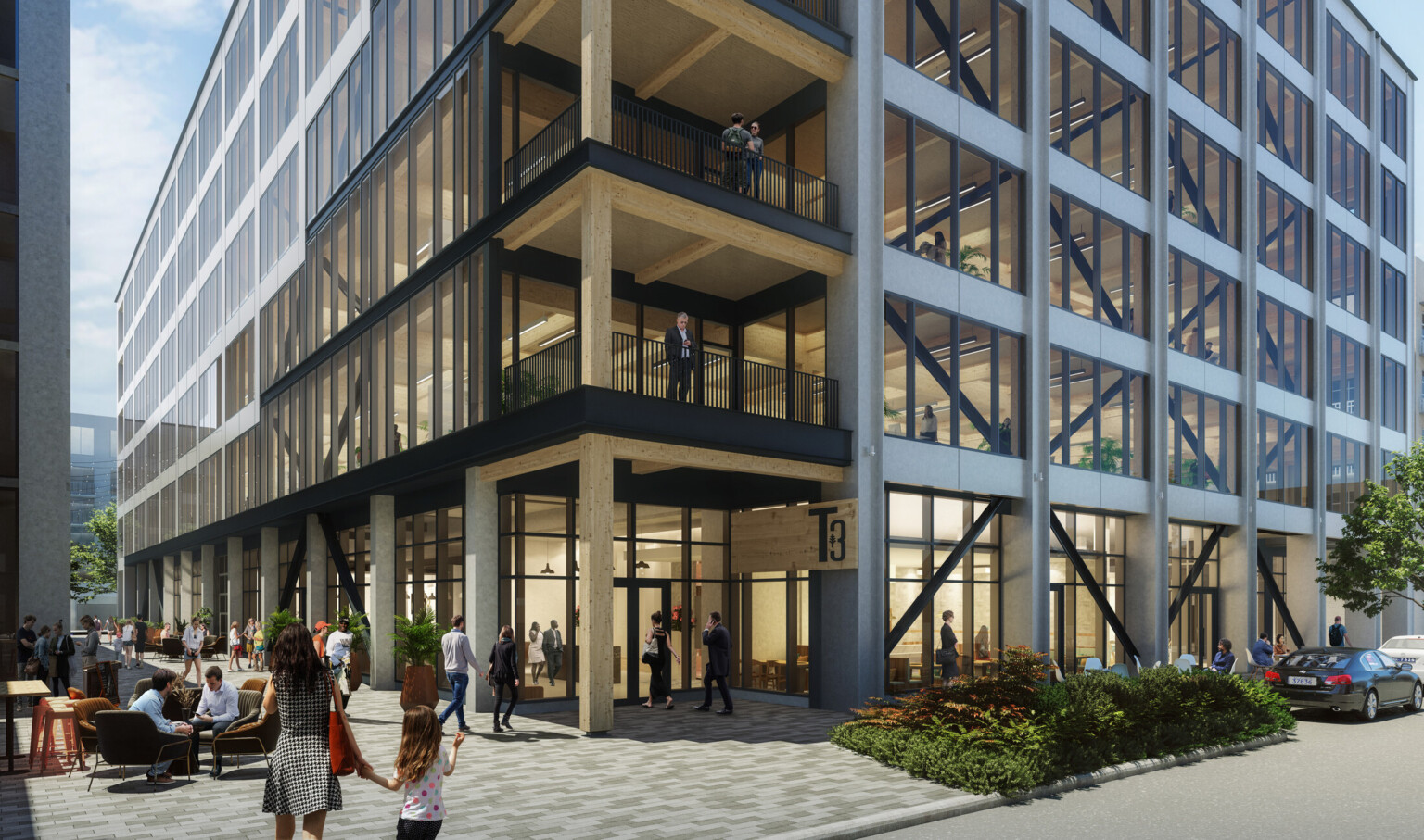 Multistory office building with black and white beams filled with windows, black railings and wooden accents