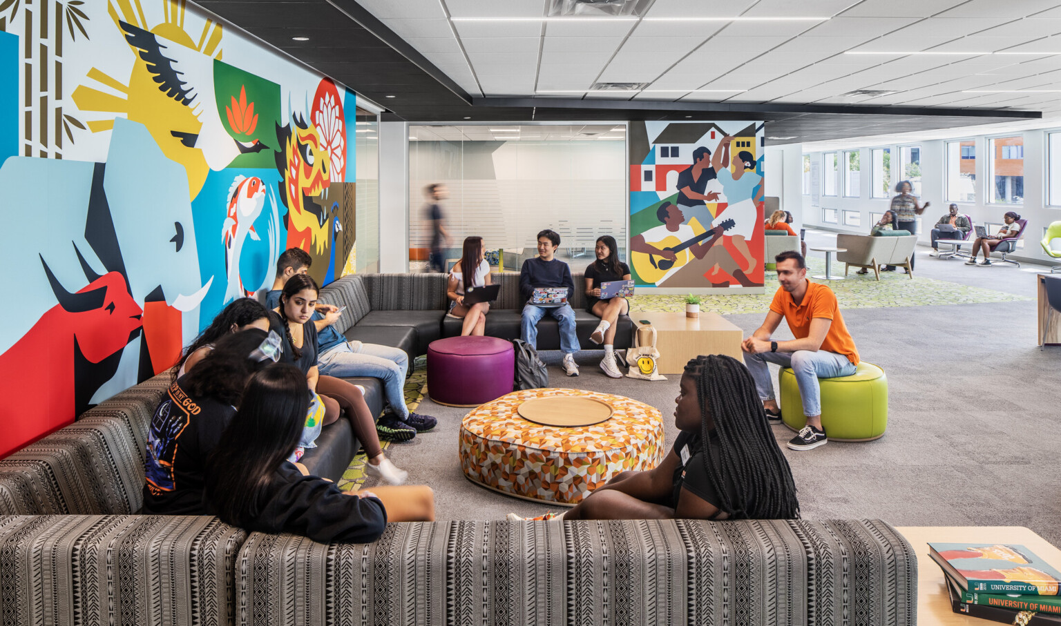 Students engaging in conversation on couches at the Whitten University Center on the University of Miami campus.