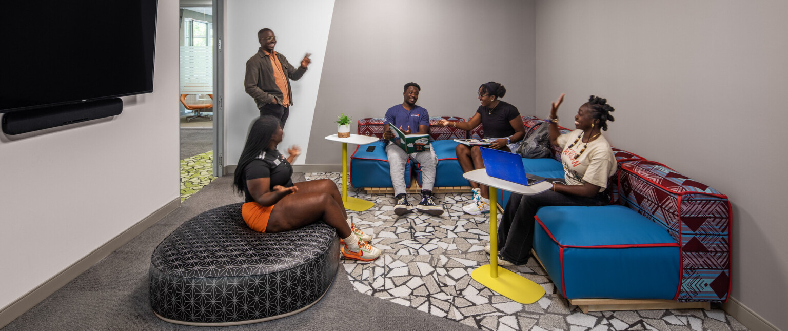 Students engaging in a lounge with colorful seating couches