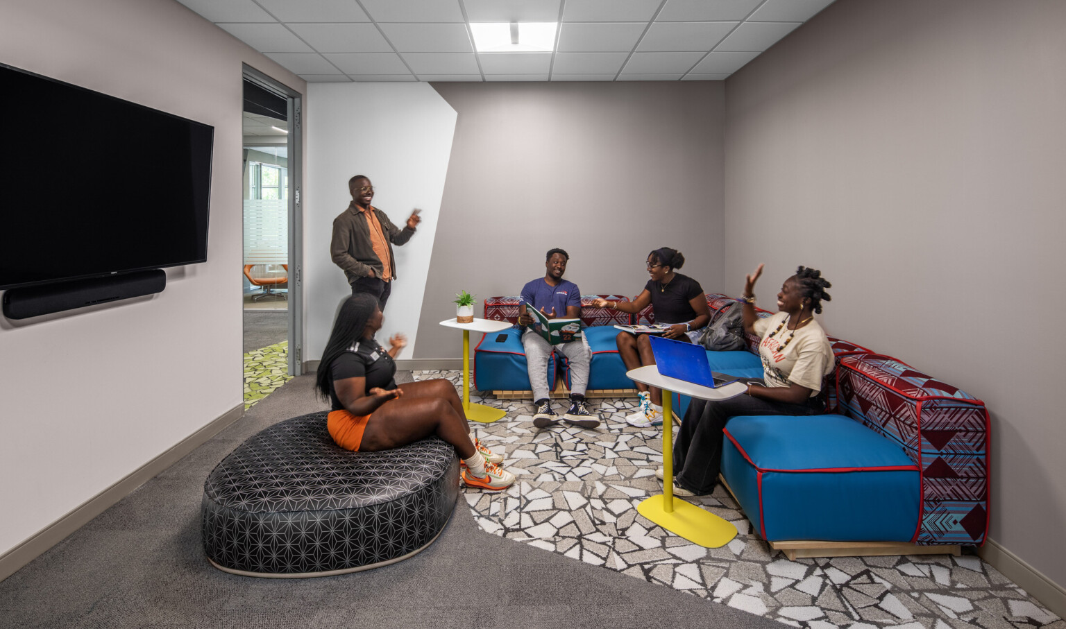 Students engaging in a lounge with colorful seating couches