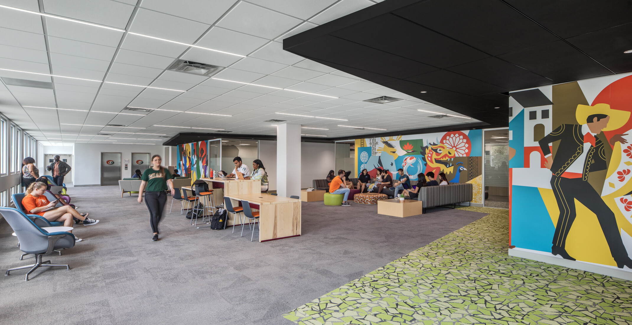 Students studying and engaging in conversation on couches at the Whitten University Center on the University of Miami campus