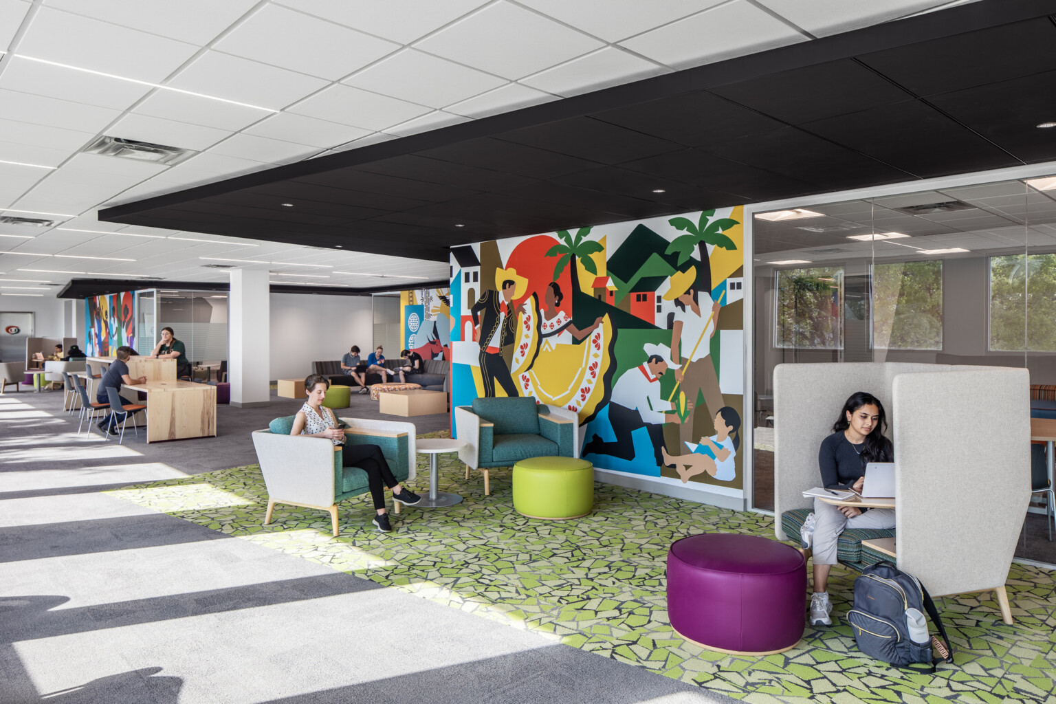 Students studying and engaging in conversation on couches at the Whitten University Center on the University of Miami campus.