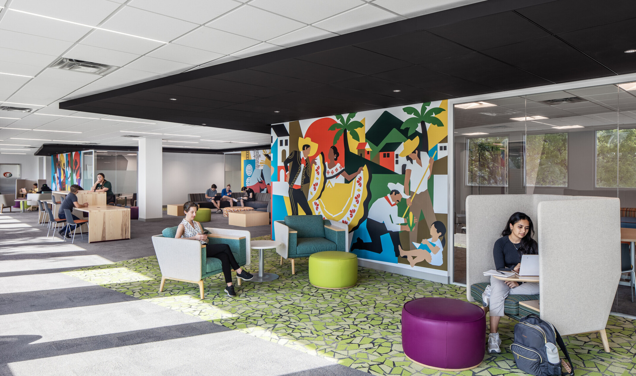 Students studying and engaging in conversation on couches at the Whitten University Center on the University of Miami campus.
