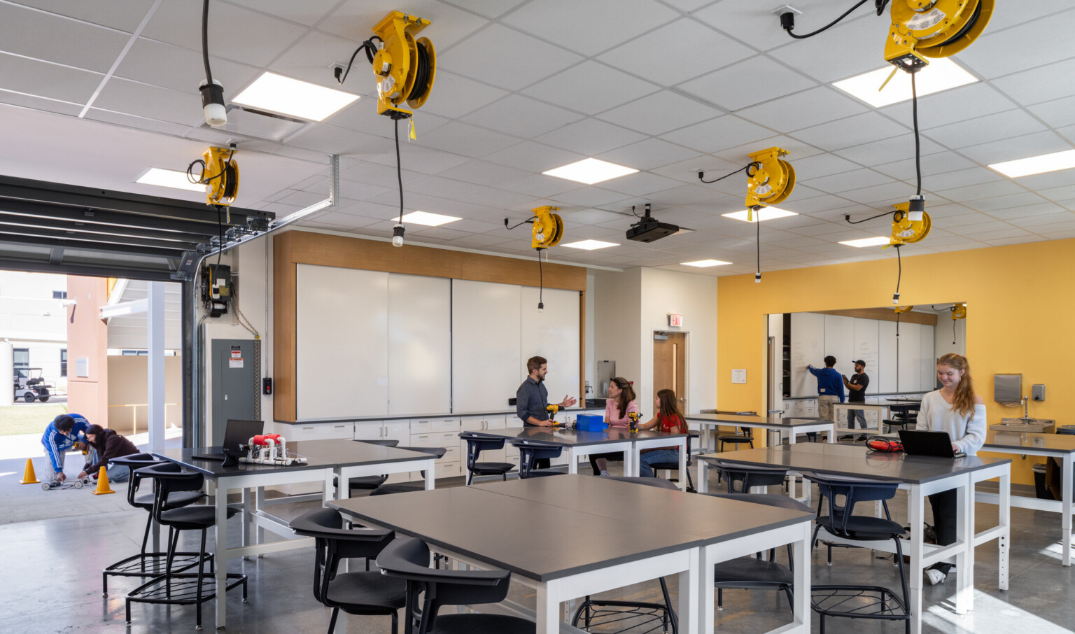modern school science lab with indoor/outdoor connection; hands-on lab stations and modular seating