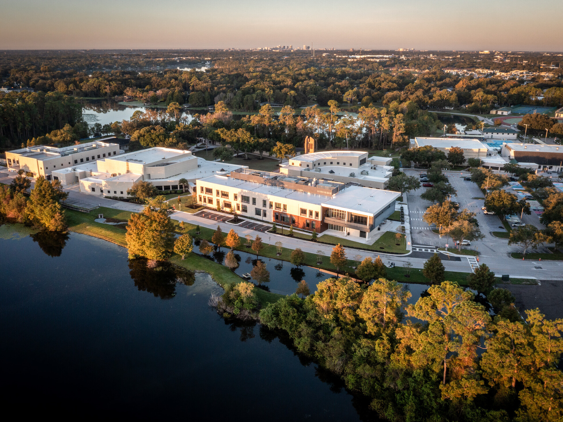 aerial image of a school campus aerial surrounded by fall colored trees and lake burkett