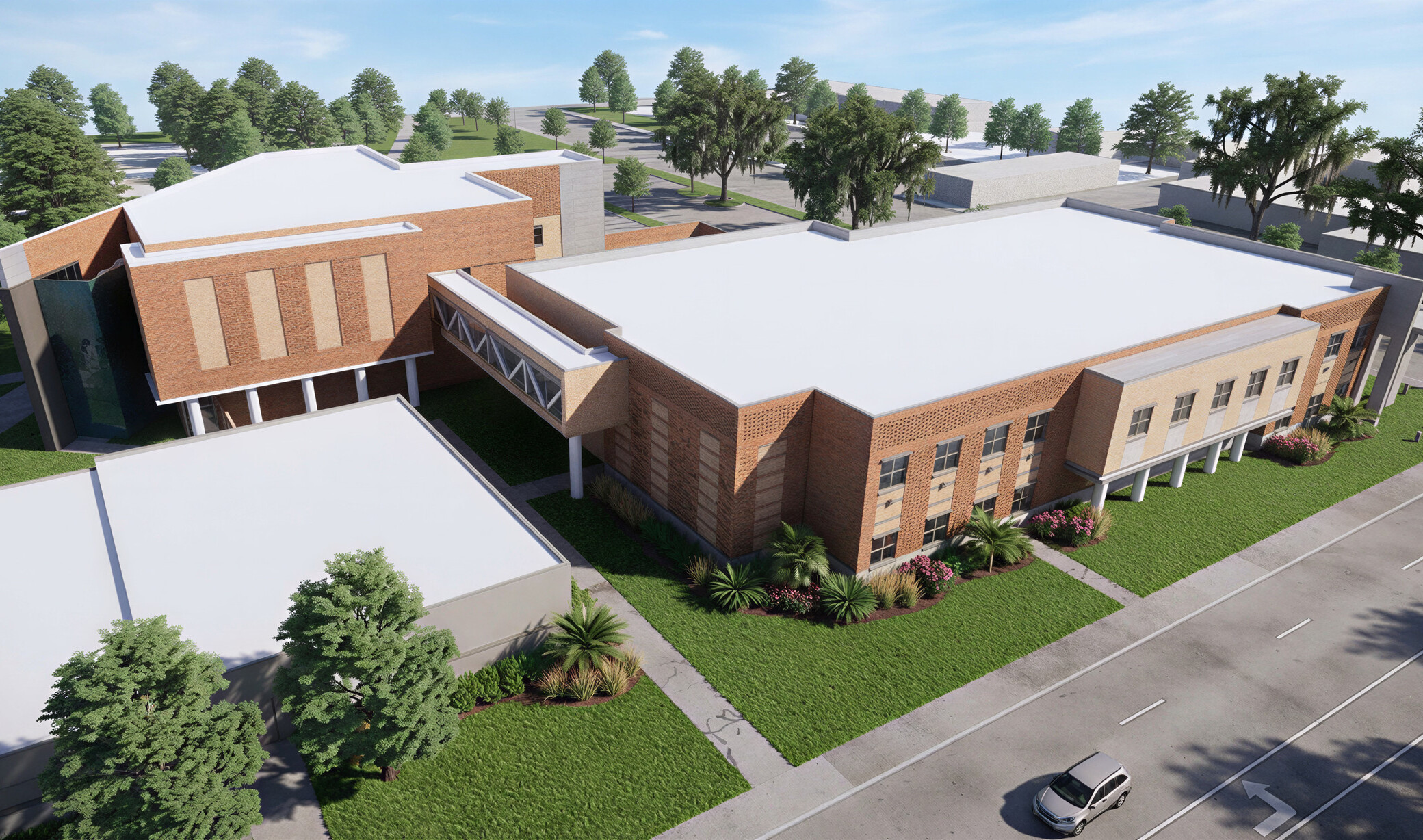 Aerial of the Police Property and Evidence Building with a light brick façade and trees surrounding the building.