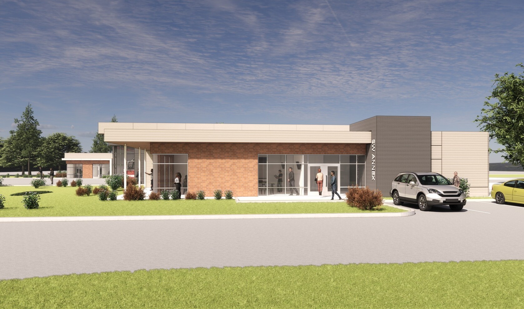 Side view of the Gainesville Southwest Public Safety Annex. Light brick façade with large windows. Parking spaces to the right.