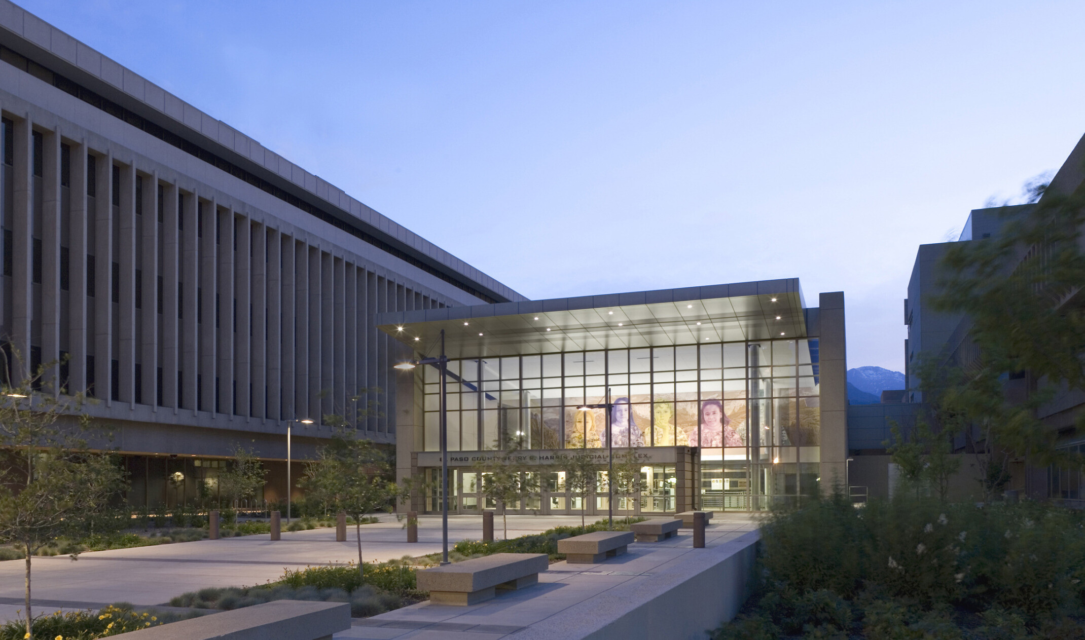 outdoor evening view looking into lobby of El Paso County Courthouse with large scale wall art inside