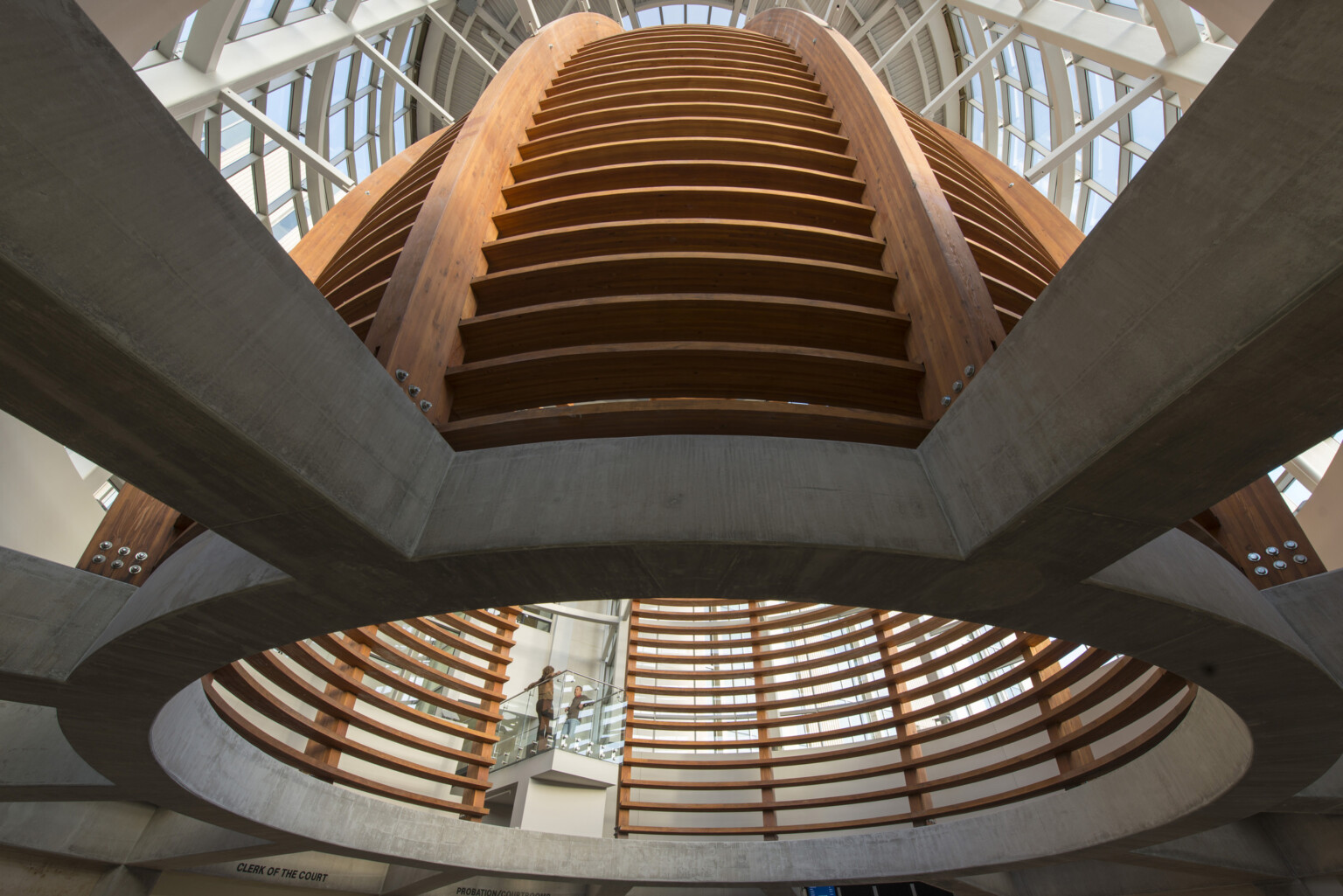 wood grid sections curve into a rotunda with view of sky above at Pueblo County Judicial Center wood grid sections curve into a rotunda with view of sky above at Pueblo County Judicial Center