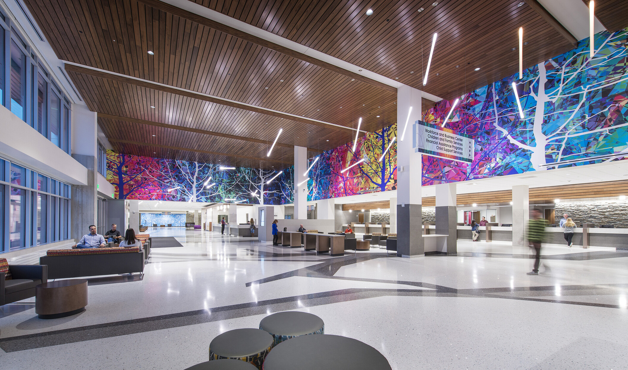 Colorful mural surrounds upper lobby wall in Adams County Pete Mirelez Human Services Center
