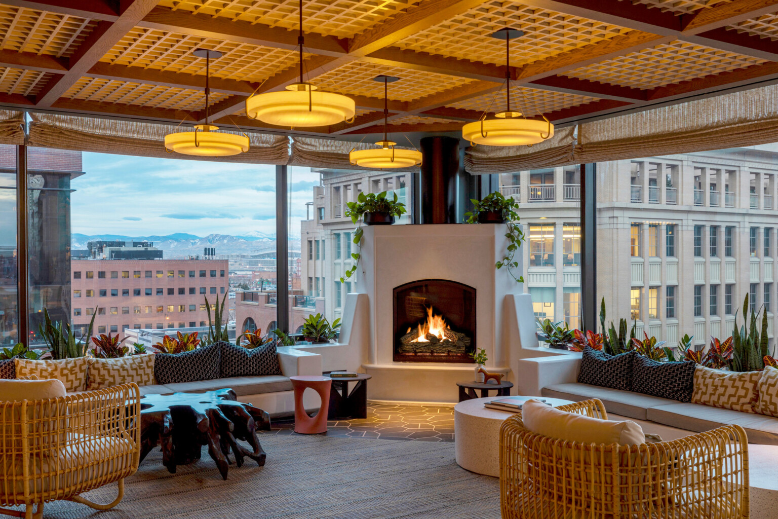 A rooftop lounge on the top of a hotel in Denver overlooking the Downtown and the beyond mountain range