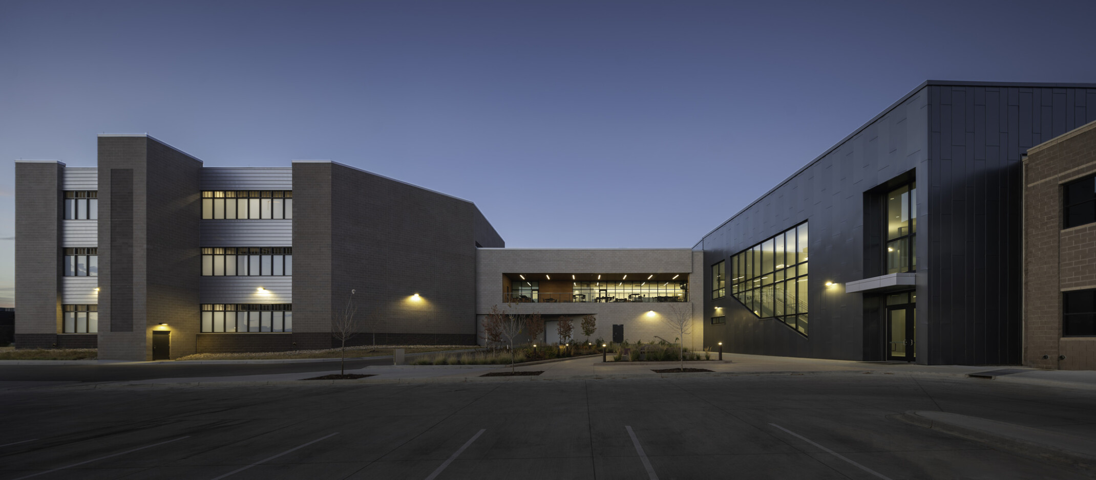 Larimer County Jail at night. Brick façade and large windows.