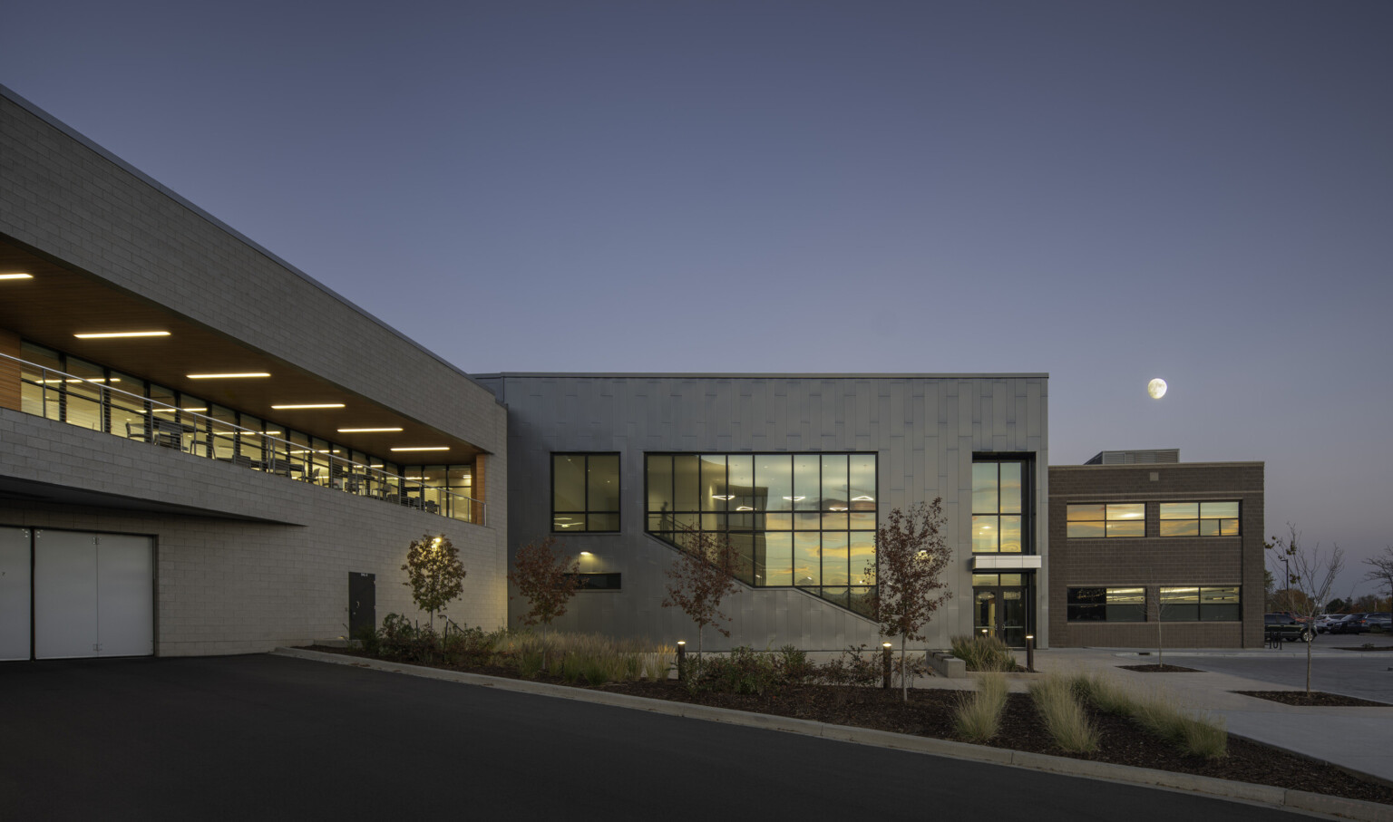 Multistory office building at night showing a brick facade with dimly lit windows