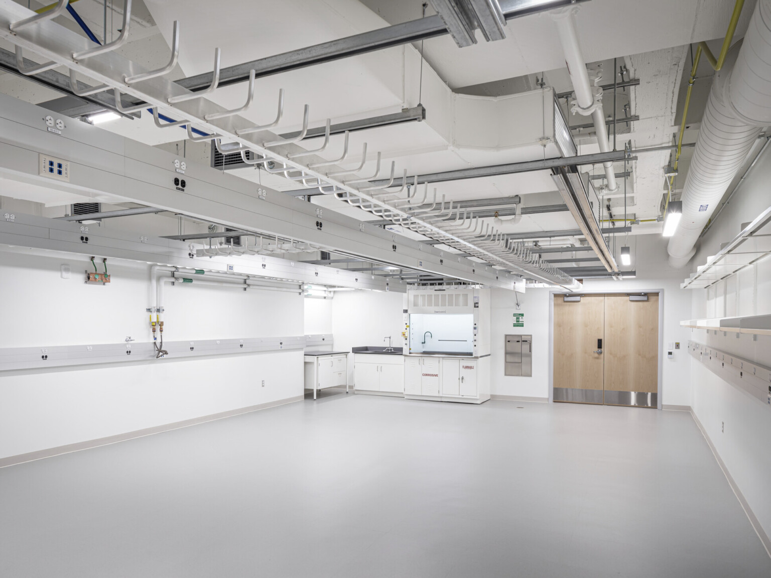 Crisp white clean lab space in National Institute of Standards and Technology overhead lighting and suport systems