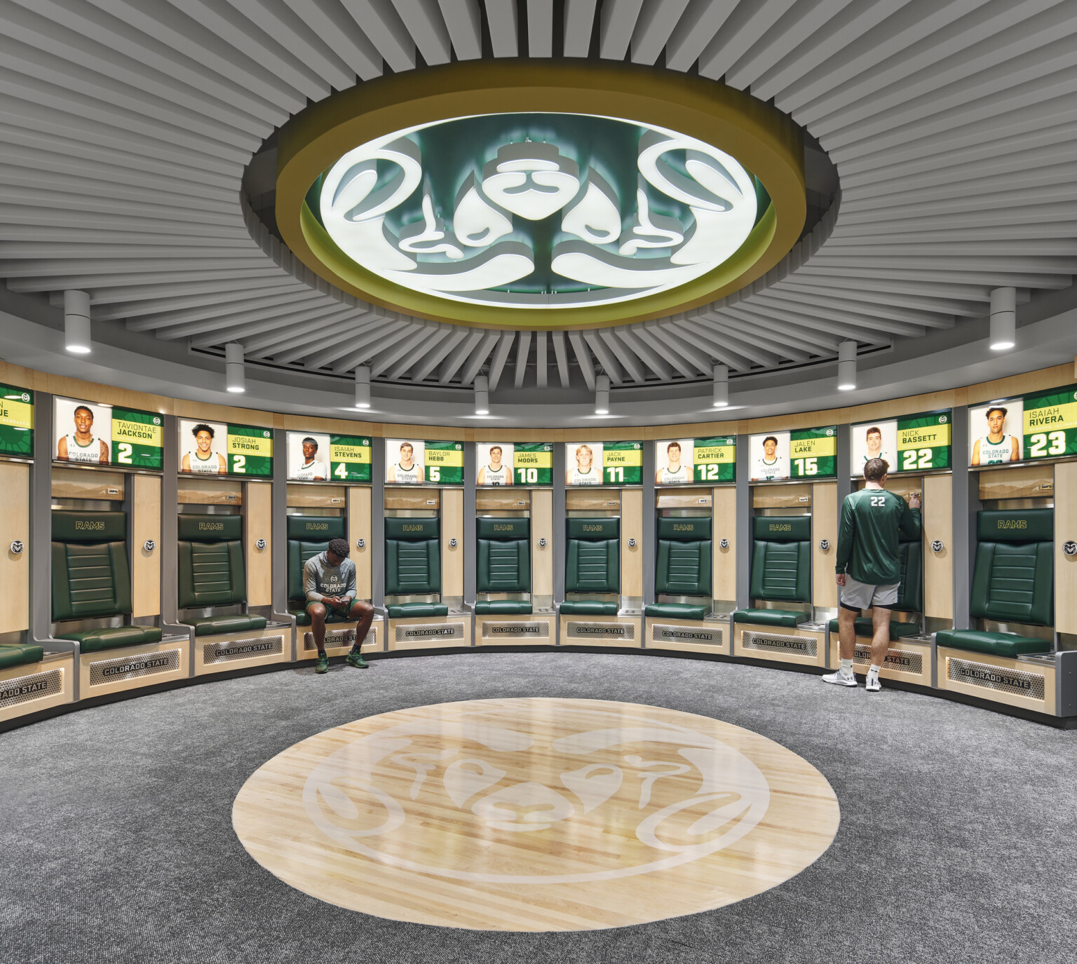 team branding, large Rams logo emblem adorns the ceiling, personalized lockers for the athletes with illuminated picture and jersey numbers of each athletes locker with private seating
