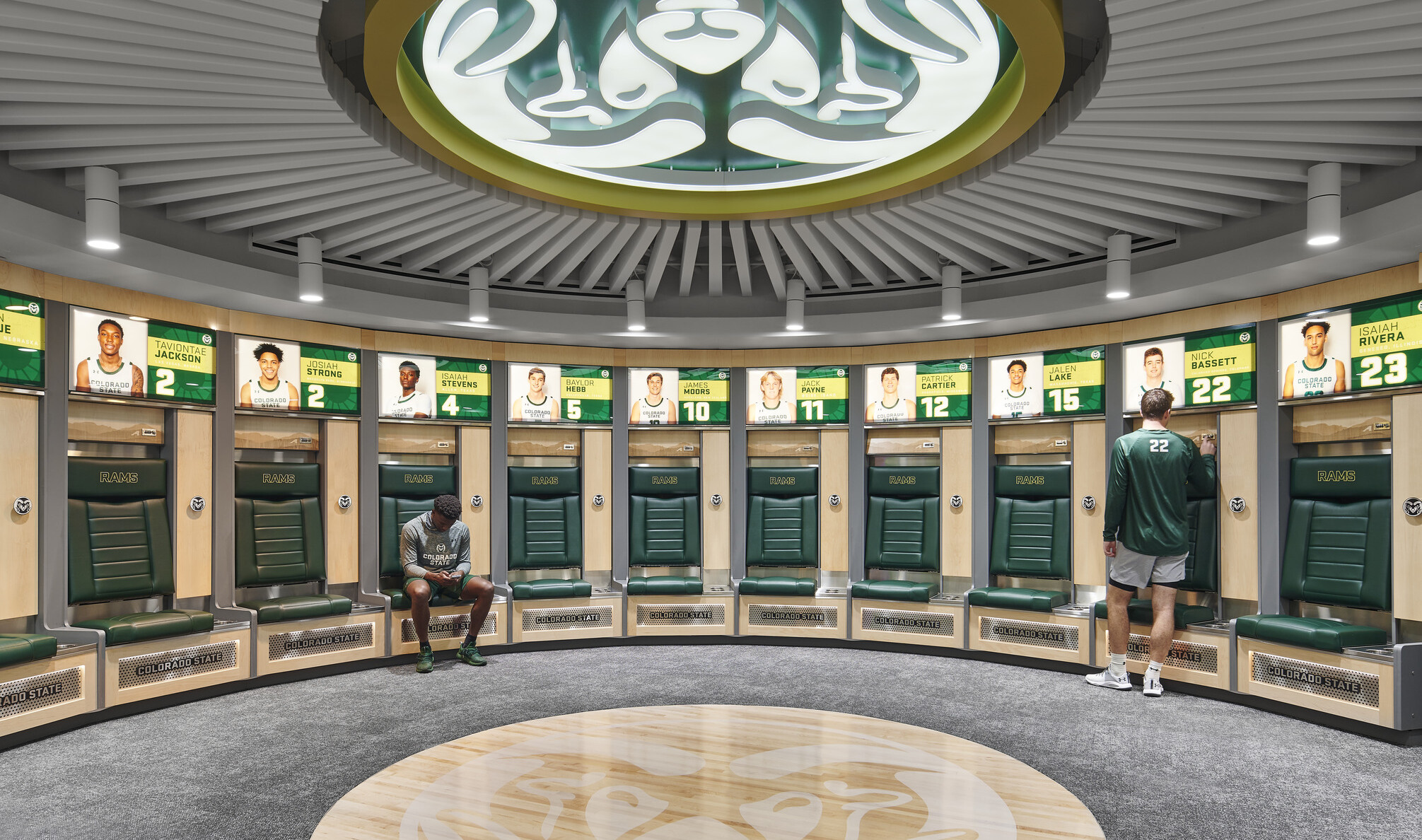 team branding, large Rams logo emblem adorns the ceiling, personalized lockers for the athletes with illuminated picture and jersey numbers of each athletes locker with private seating
