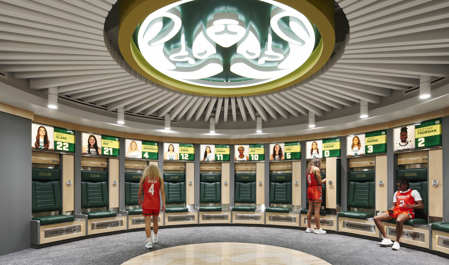 team branding, large Rams logo emblem adorns the ceiling, lockers for the women athletes with illuminated picture and jersey numbers of each athletes locker with private seating