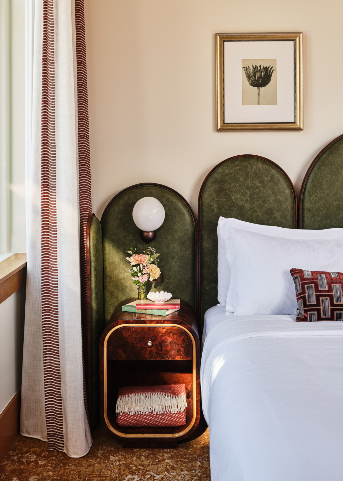 boutique hotel room design with emerald green leather headboard, midcentury modern design, nightstand and sconces