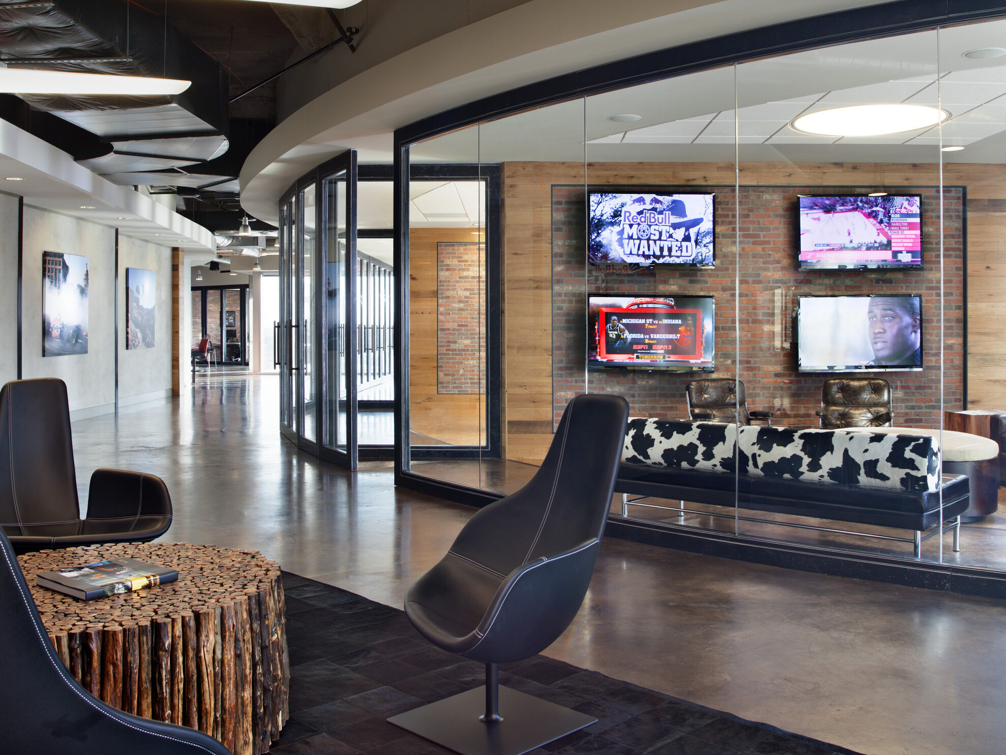 modern office walkway; modular furniture in the forefront with a glass fishbowl conference room in the background