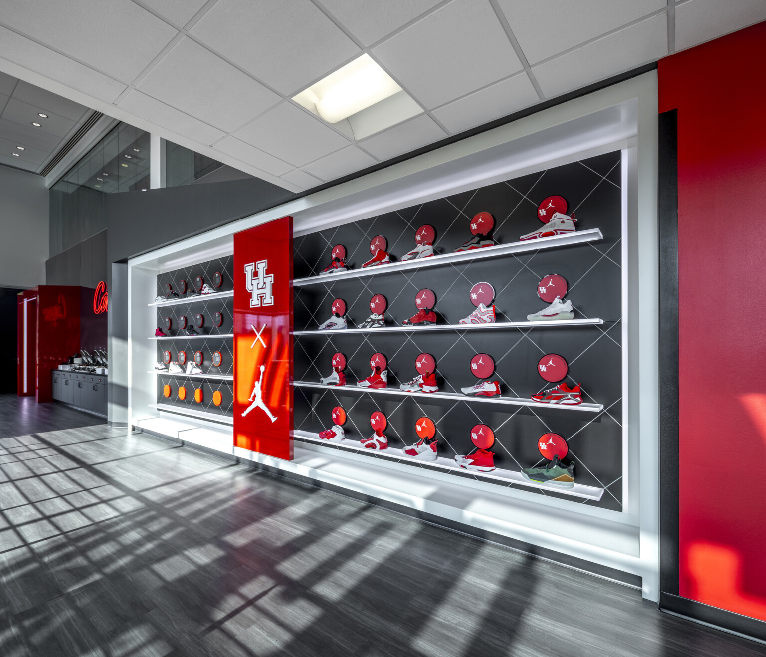 wall of a university of houston sports facility; brightly colored air jordan basketball shoes decorate the wall