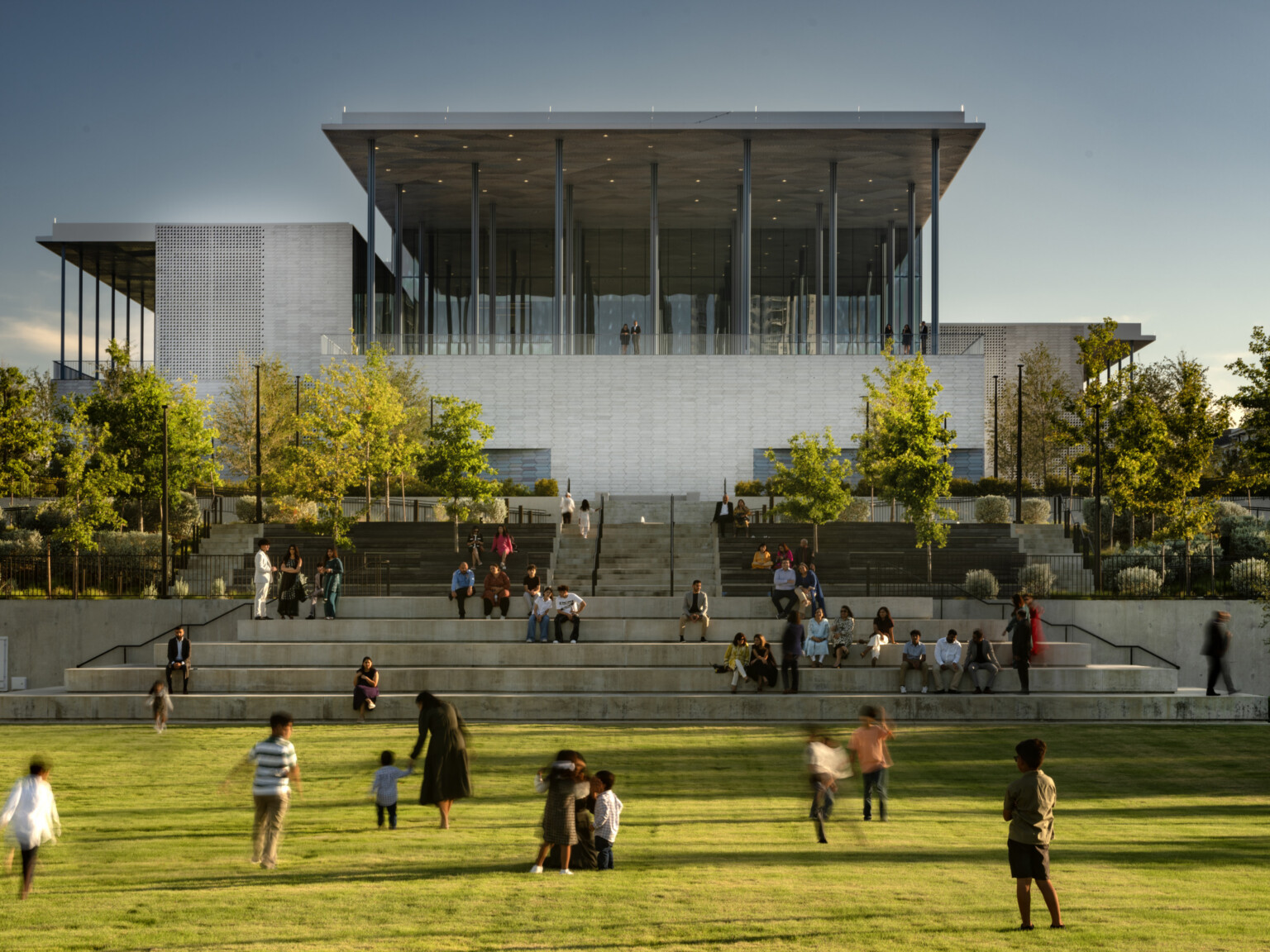Front lawn of Ismaili Center, Houston; people playing in grass