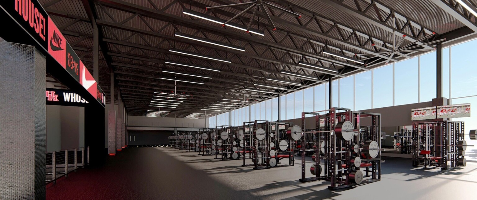workout center with free-weights, exercise machines, clerestory windows bring in natural light, branded wall clock/signage